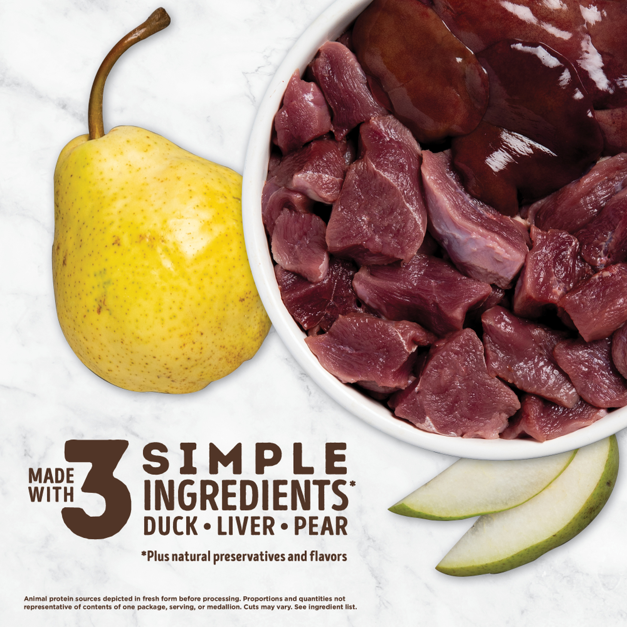 ACANA Free-Run Duck treats made with 3 simple ingredients, duck, liver and pear, shown as raw duck and duck liver in a bowl with a fresh pear on marble