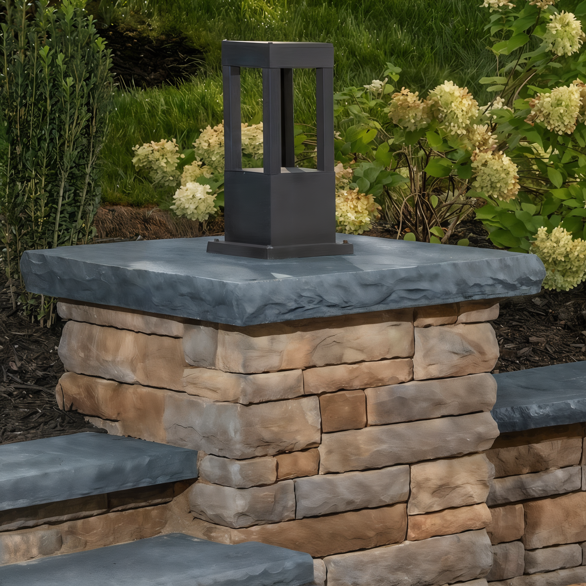 Belgard Belmont cast stone pier cap in Bluestone blue-grey on a brown stacked stone column