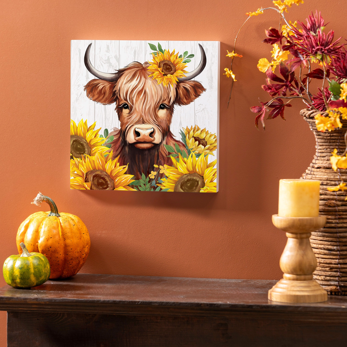 Evergreen Harvest Blossom Highland Cow and Sunflowers Wall Decor -- on a wall above a fall console table
