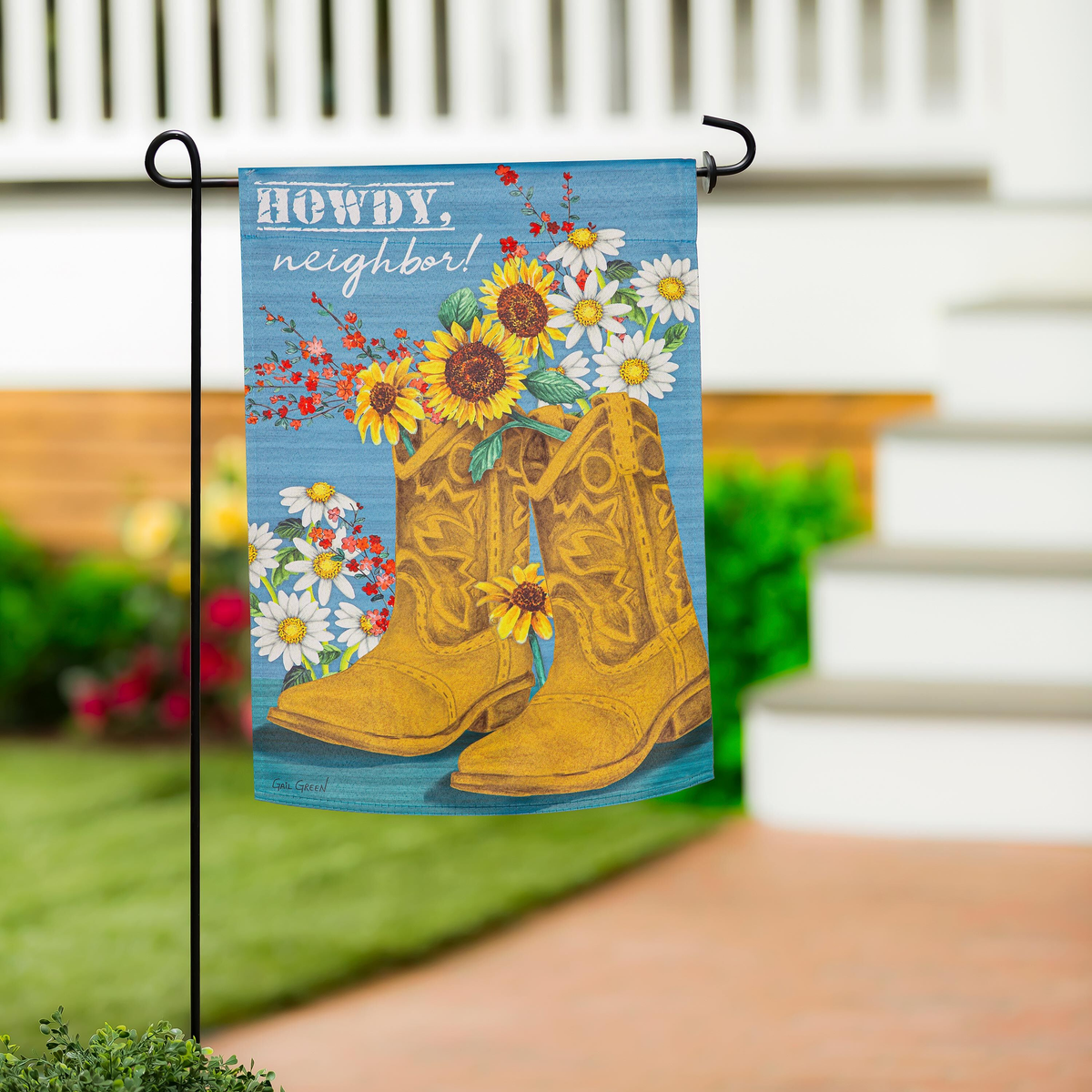 Evergreen Western Boots Suede Flag -- garden flag displayed on a stand beside porch steps