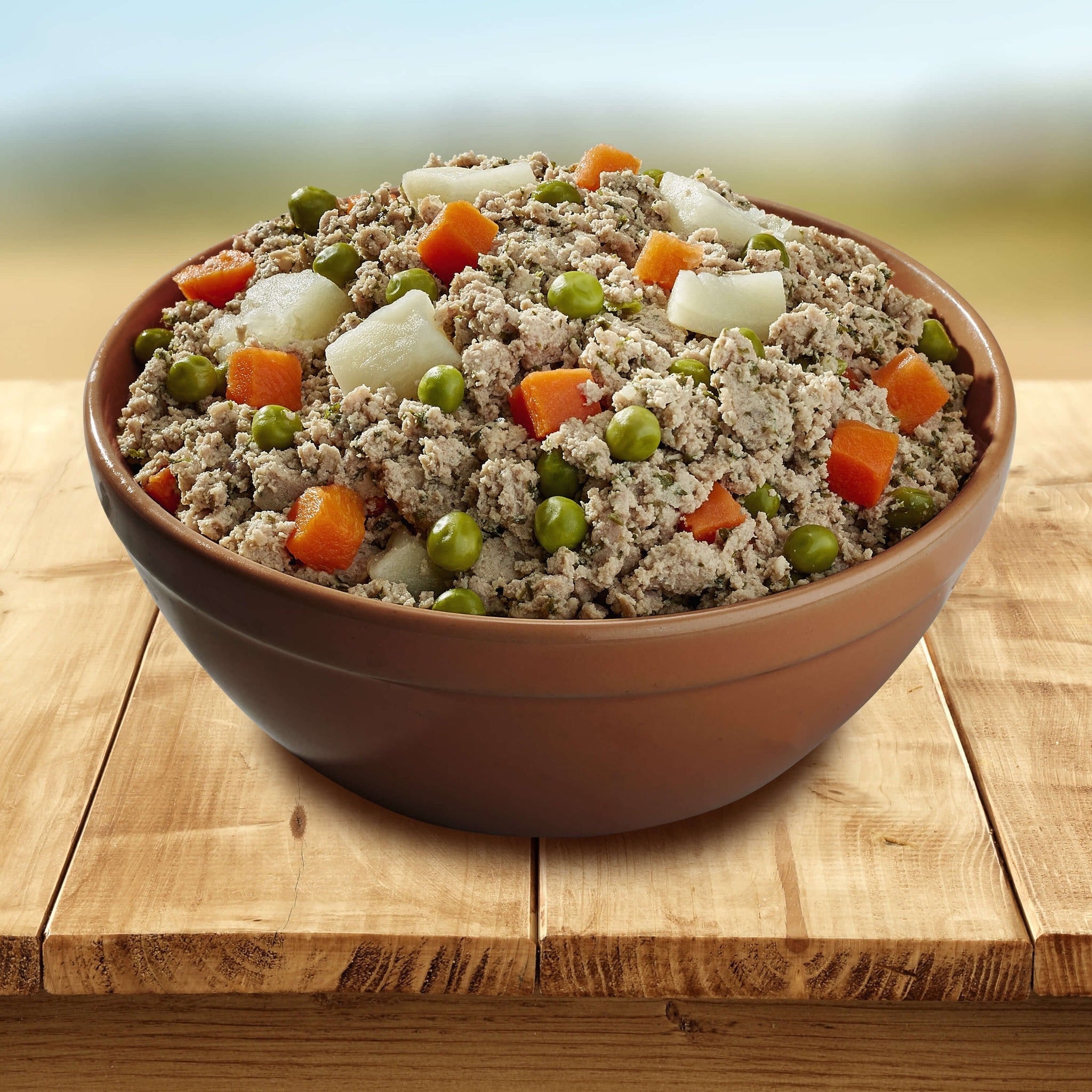 Bowl of Bonnihill Farms TurkiBowls gently cooked turkey recipe with peas, carrots, and potatoes