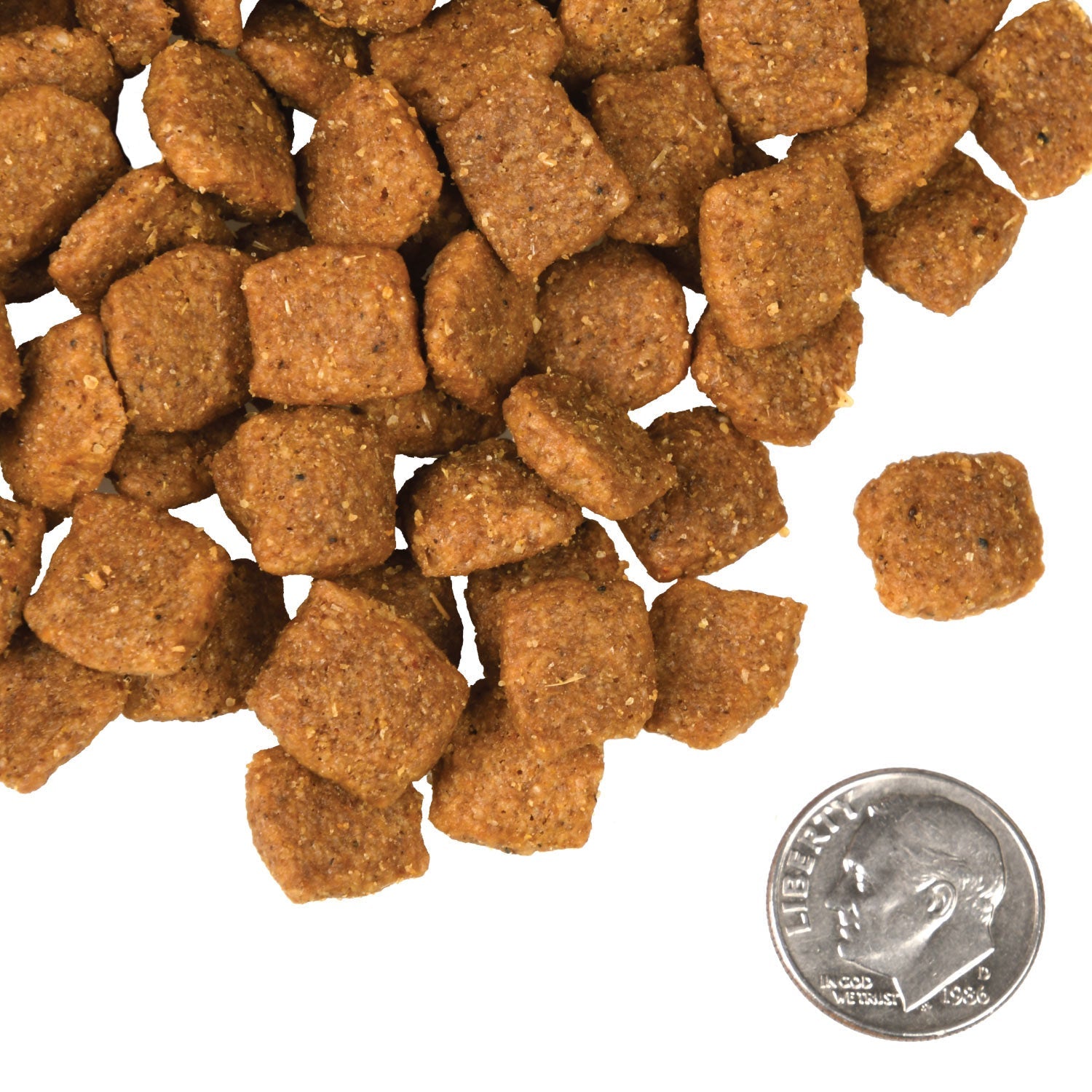 A small pile of Fromm Chicken A La Veg kibble next to a dime for scale