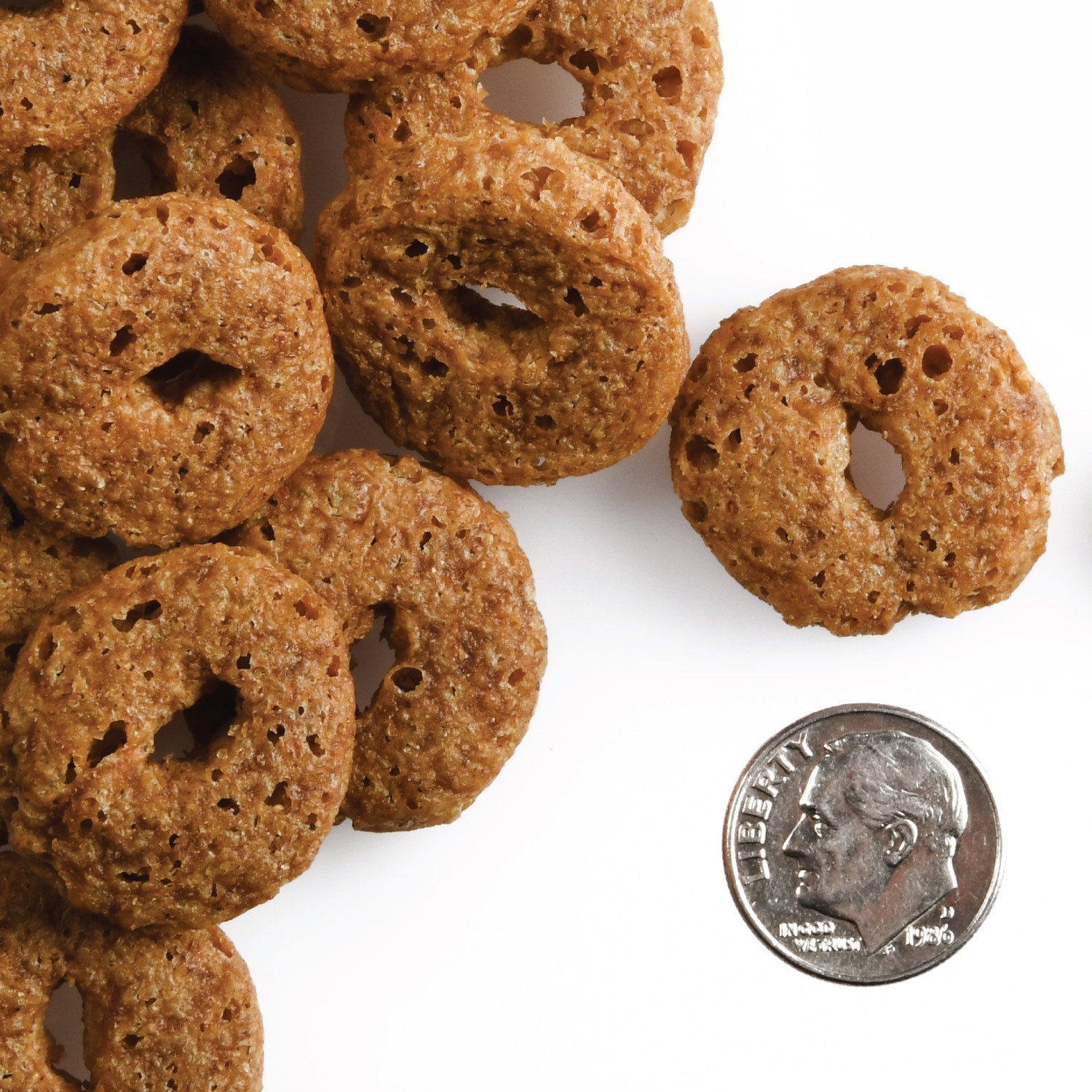 Fromm Crunchy O's O-shaped treats shown next to a dime for scale