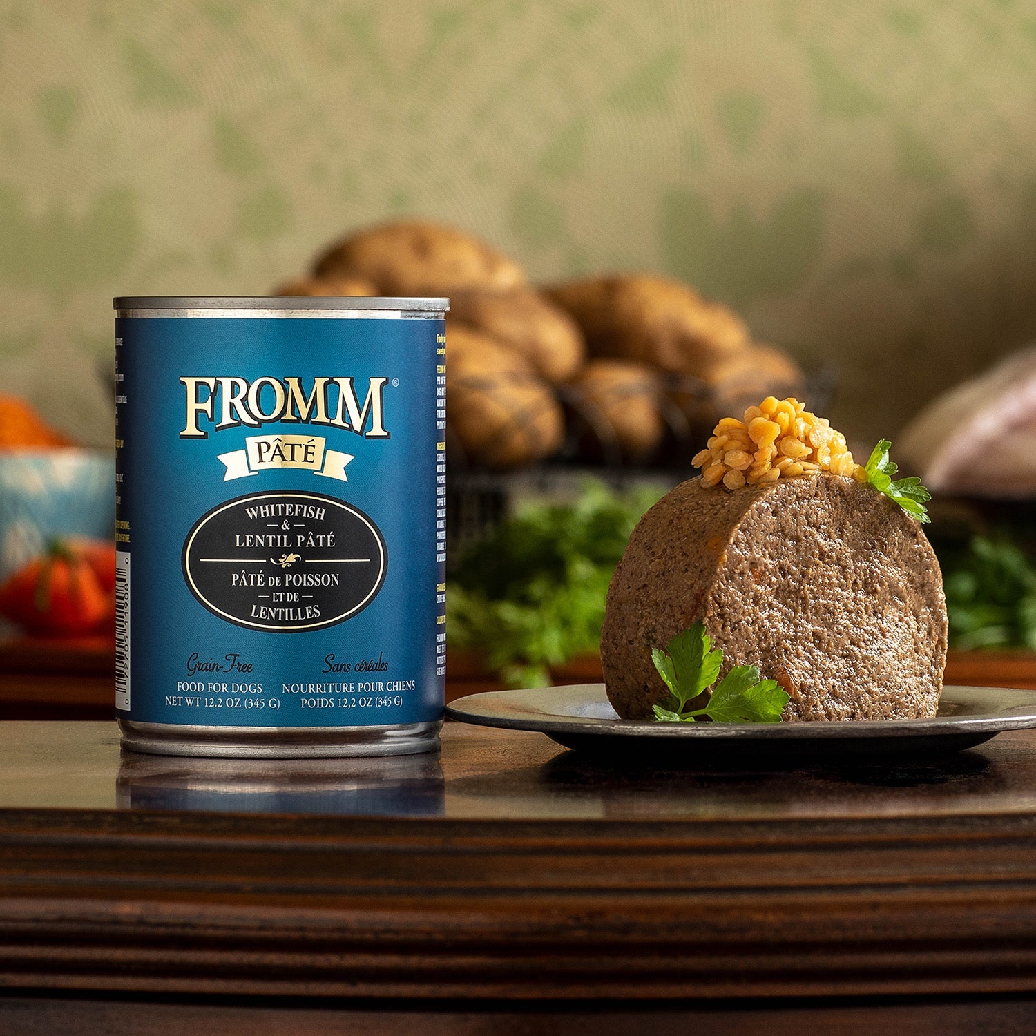 A can of Fromm Pâté Whitefish & Lentil beside a plated pâté portion topped with lentils and parsley