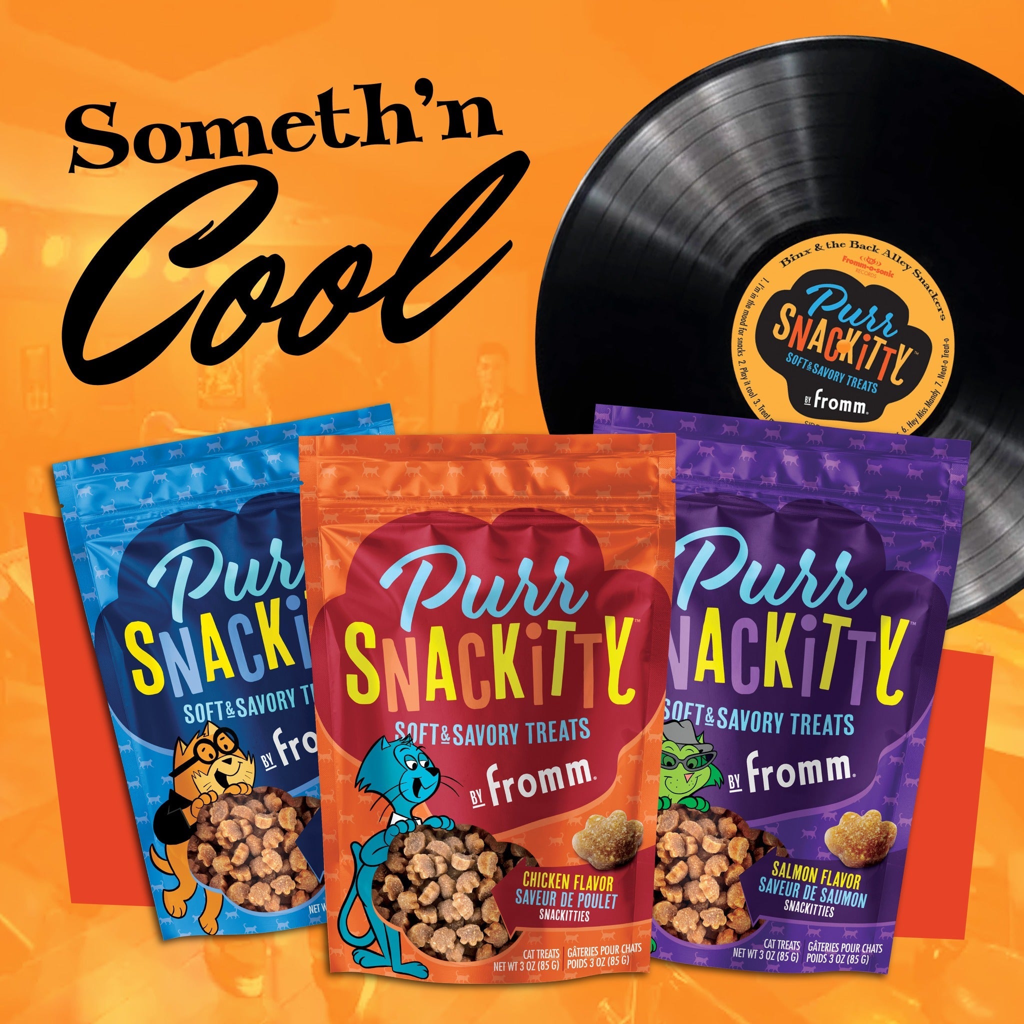 PurrSnackitty Soft and Savory Treats lineup: chicken, salmon, and liver flavor bags with a Binx and the Back Alley Snackers record