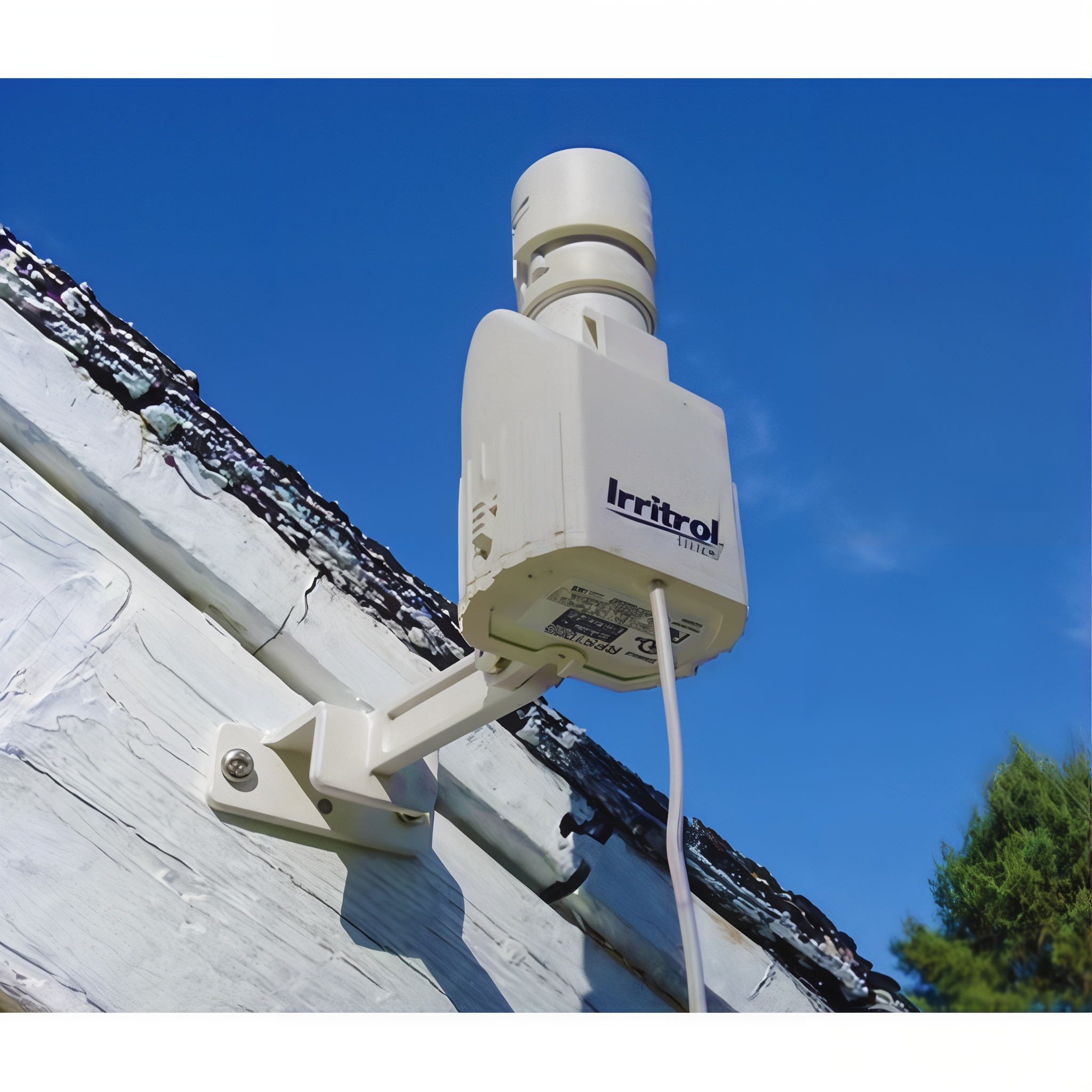 Irritrol wireless rain sensor transmitter installed on a roof eave with Quick-Clip gutter bracket