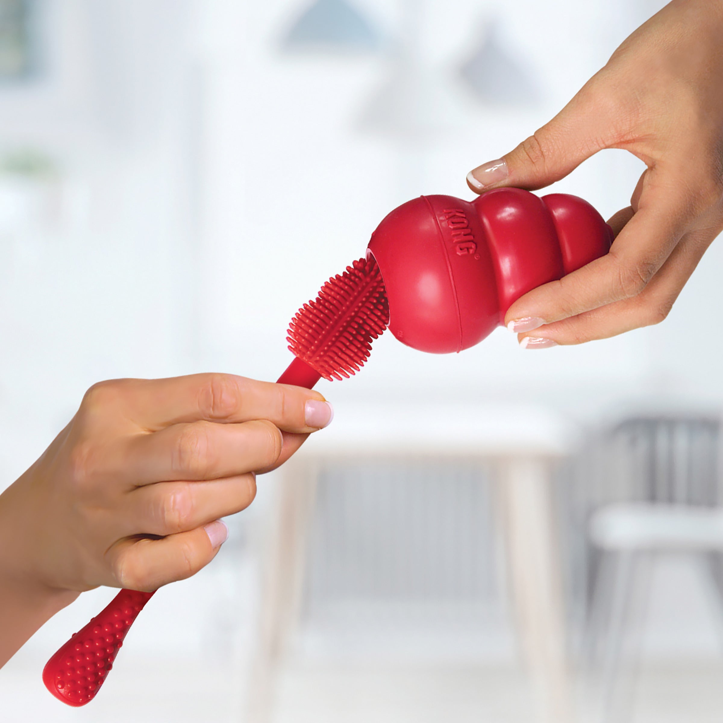 Cleaning a KONG Classic dog toy with the KONG Cleaning Brush