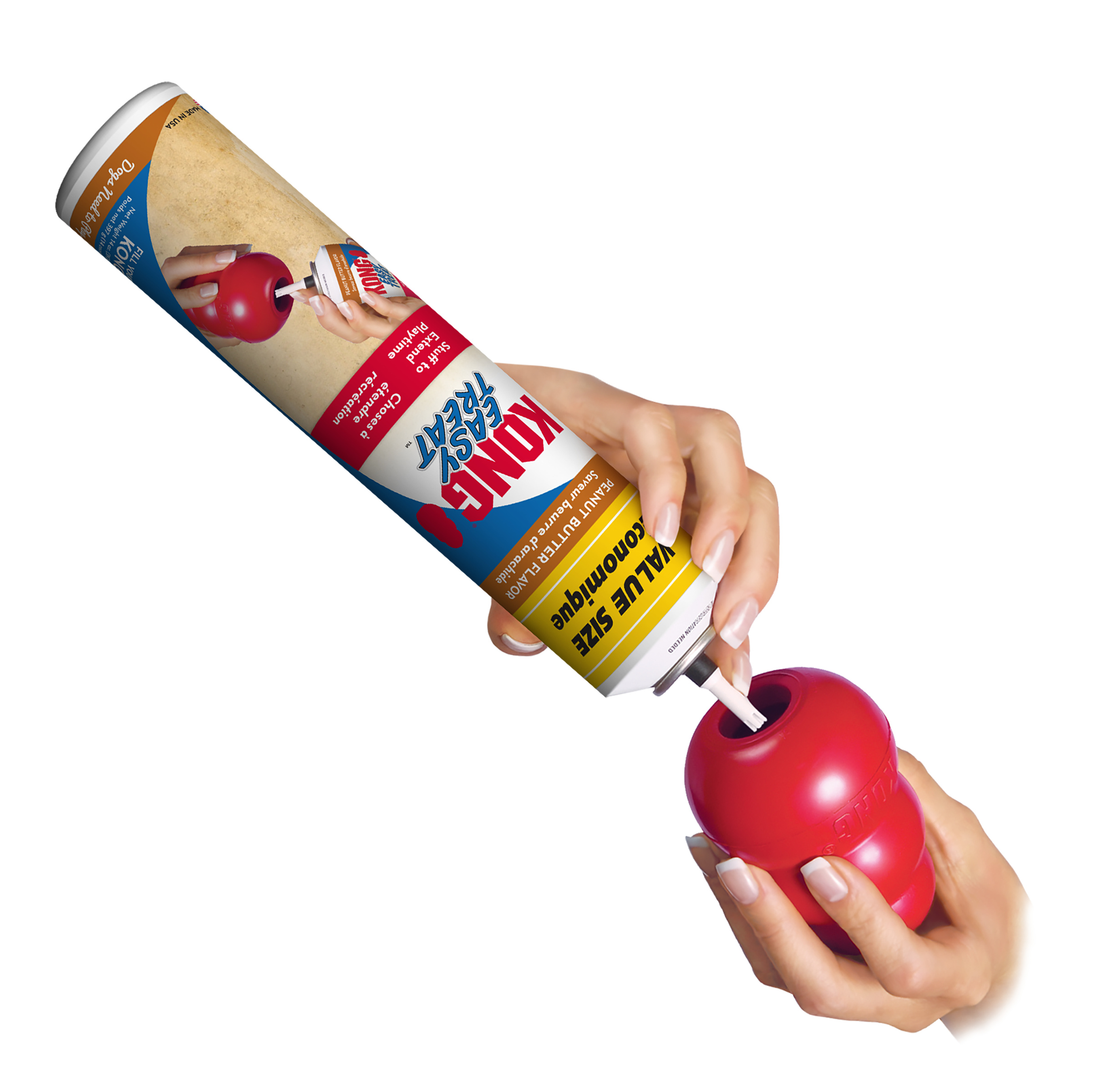 Hand squeezing KONG Easy Treat Peanut Butter into a KONG toy