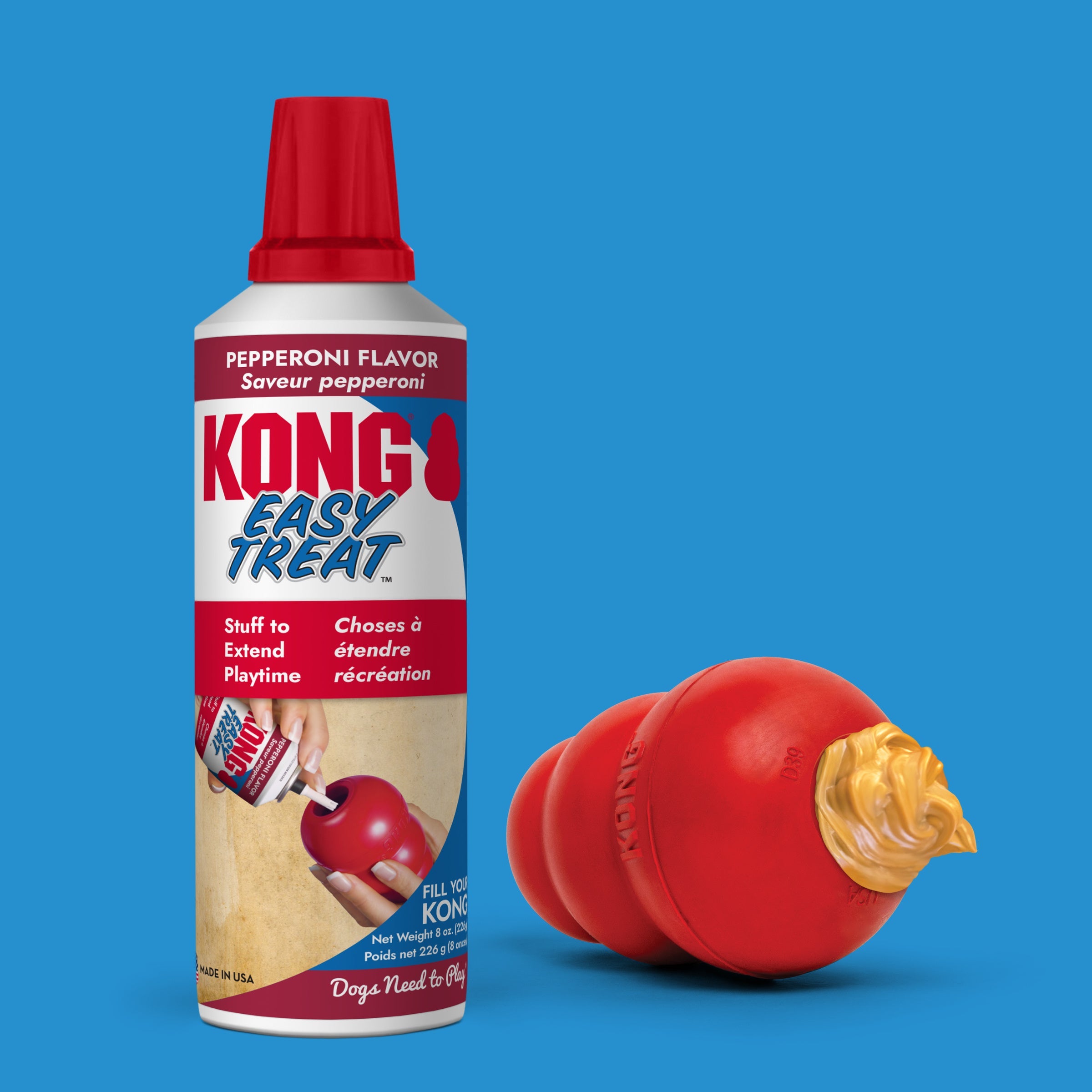 KONG Easy Treat Pepperoni can next to a KONG Classic toy filled with treat paste