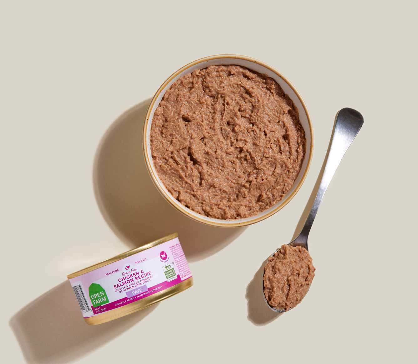 Open Farm chicken & salmon pâté served in a bowl beside the can and a spoon