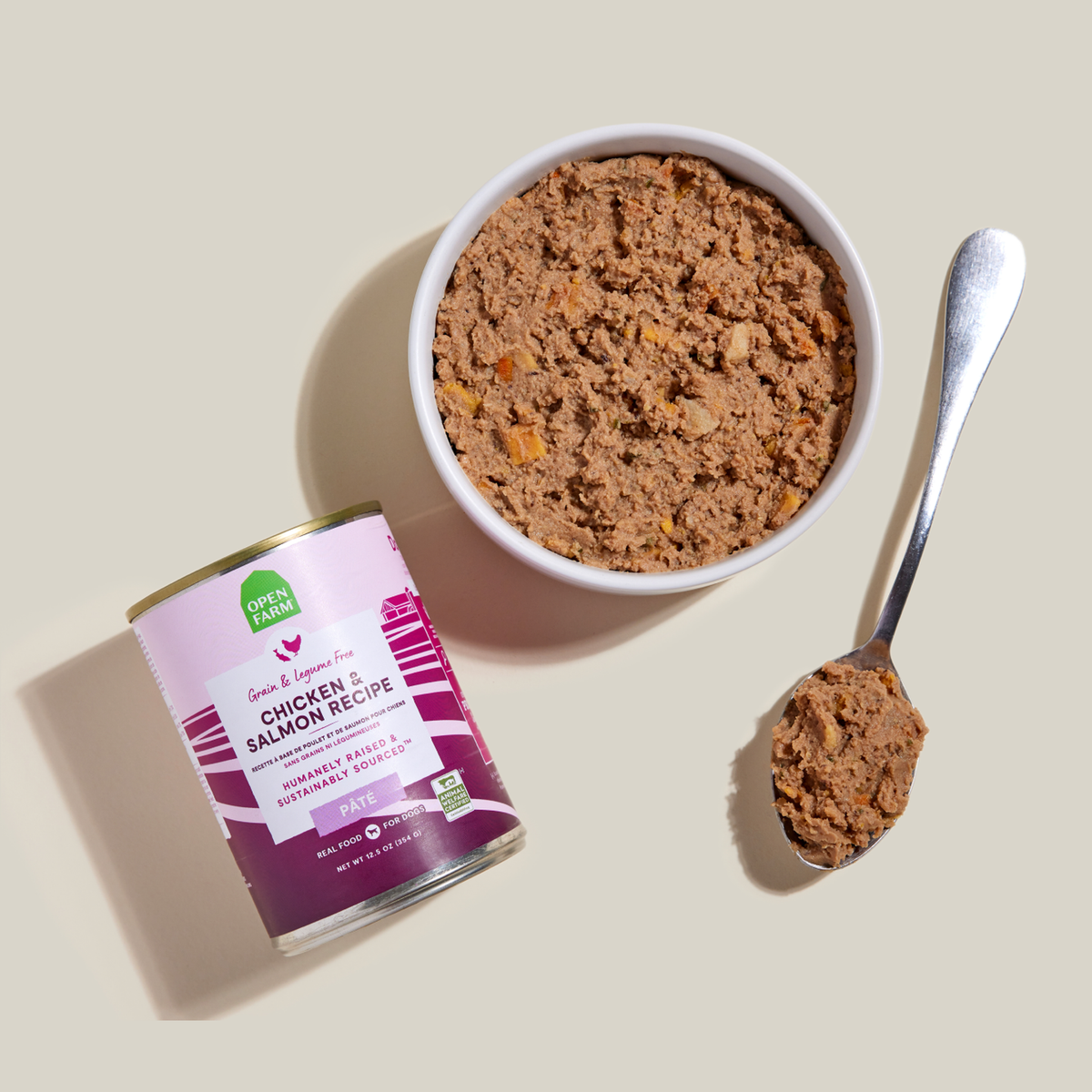 Open Farm Chicken & Salmon Pâté for Dogs -- 12.5 oz can beside a bowl of food