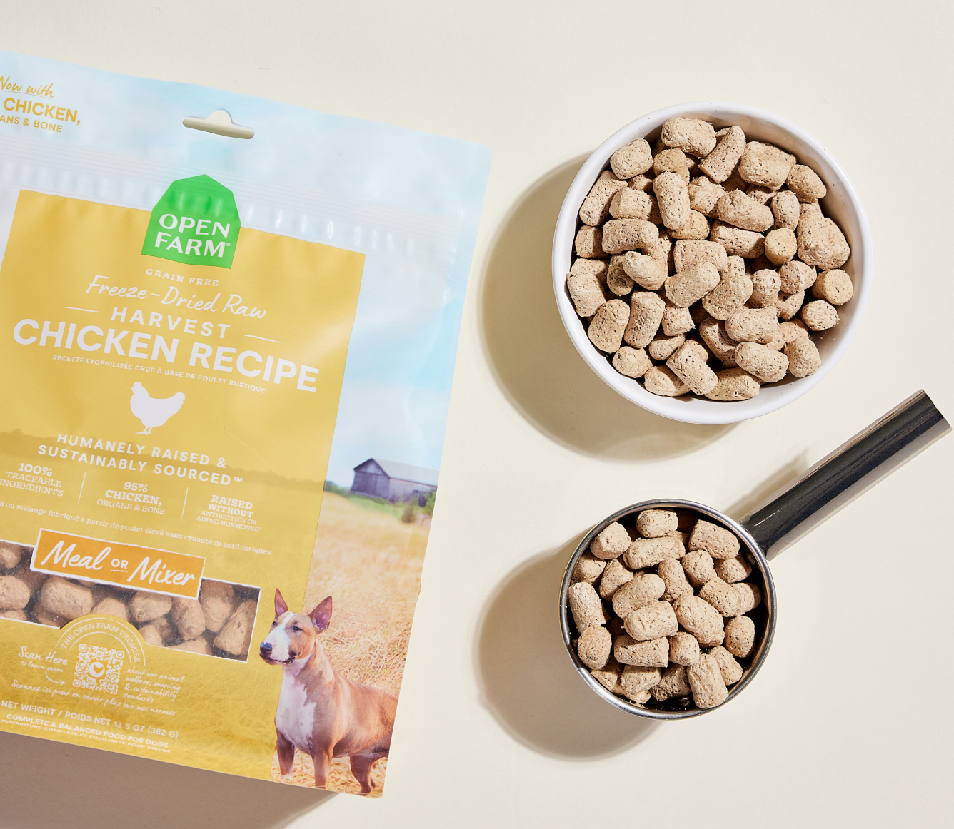 Open Farm Harvest Chicken freeze dried morsels in a bowl and measuring scoop