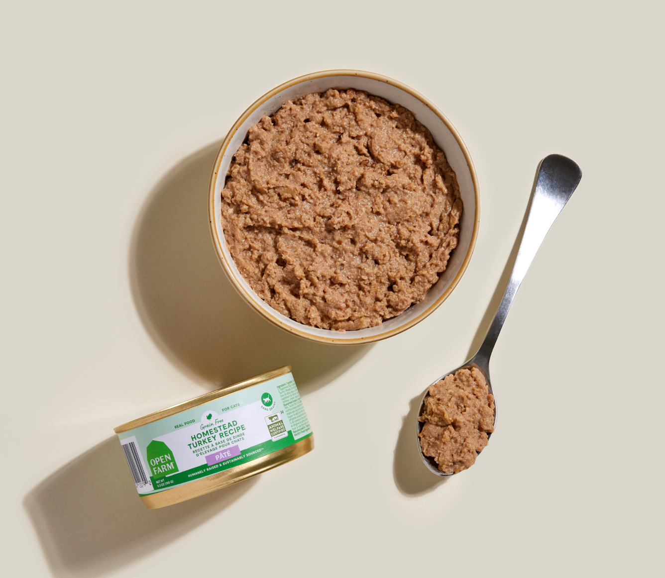 Open Farm homestead turkey pâté served in a bowl beside the can and a spoon