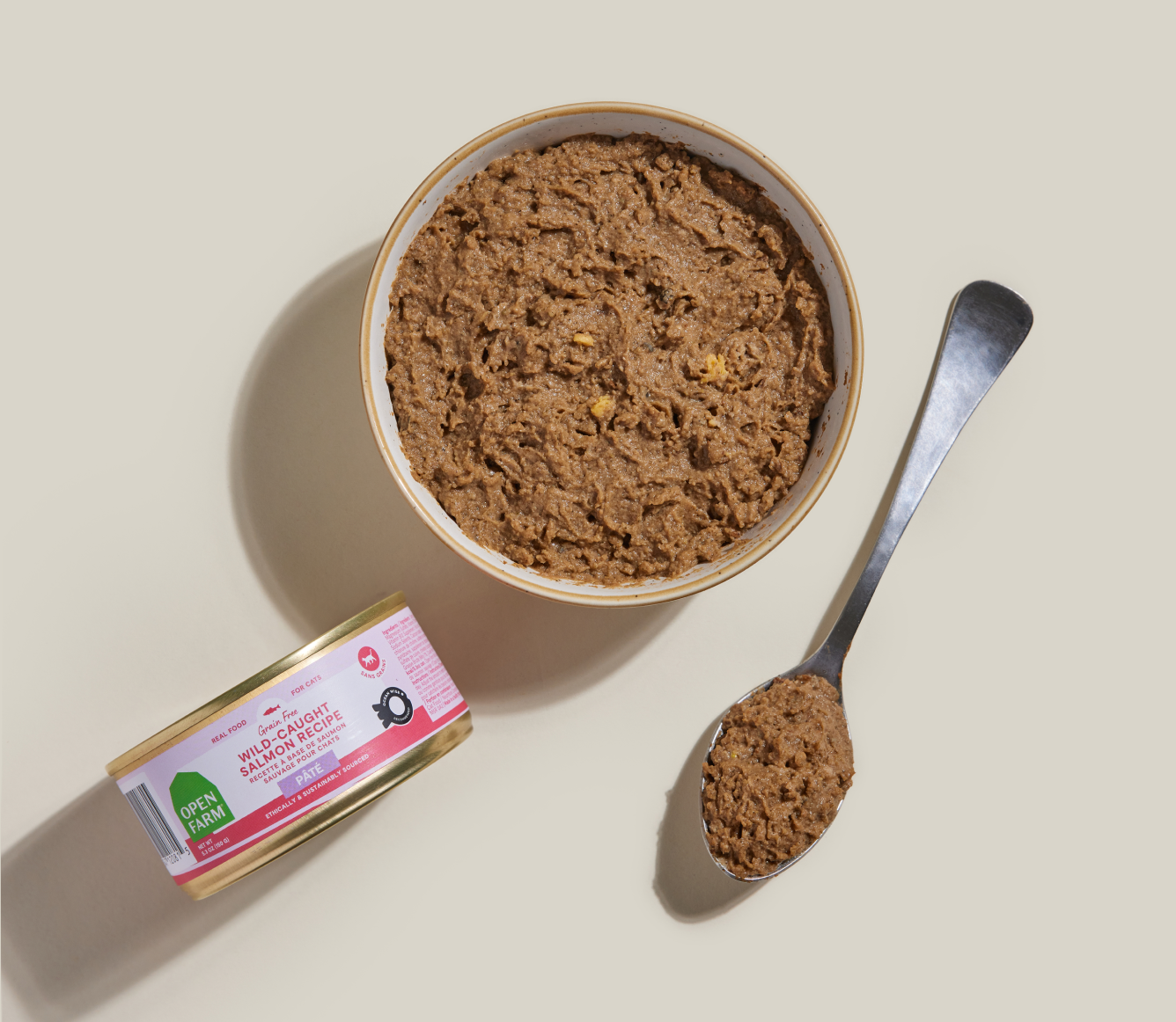 Open Farm salmon pâté served in a bowl beside the 5.3 oz can and a spoon
