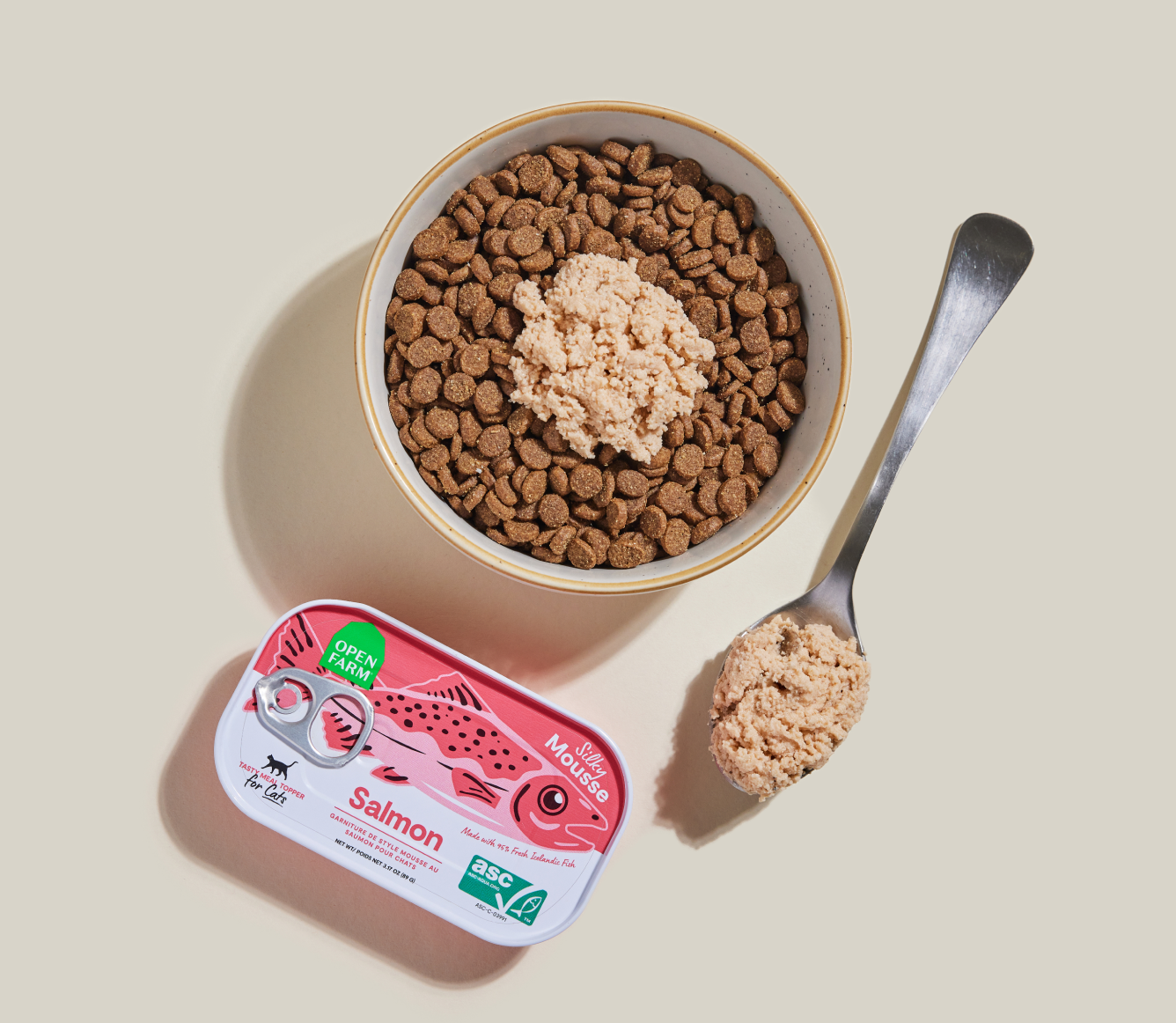 Open Farm Salmon Topper served over kibble in a bowl with a spoon