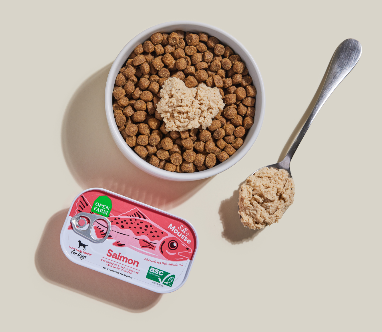 Open Farm Salmon Topper served over kibble in a bowl with a spoon