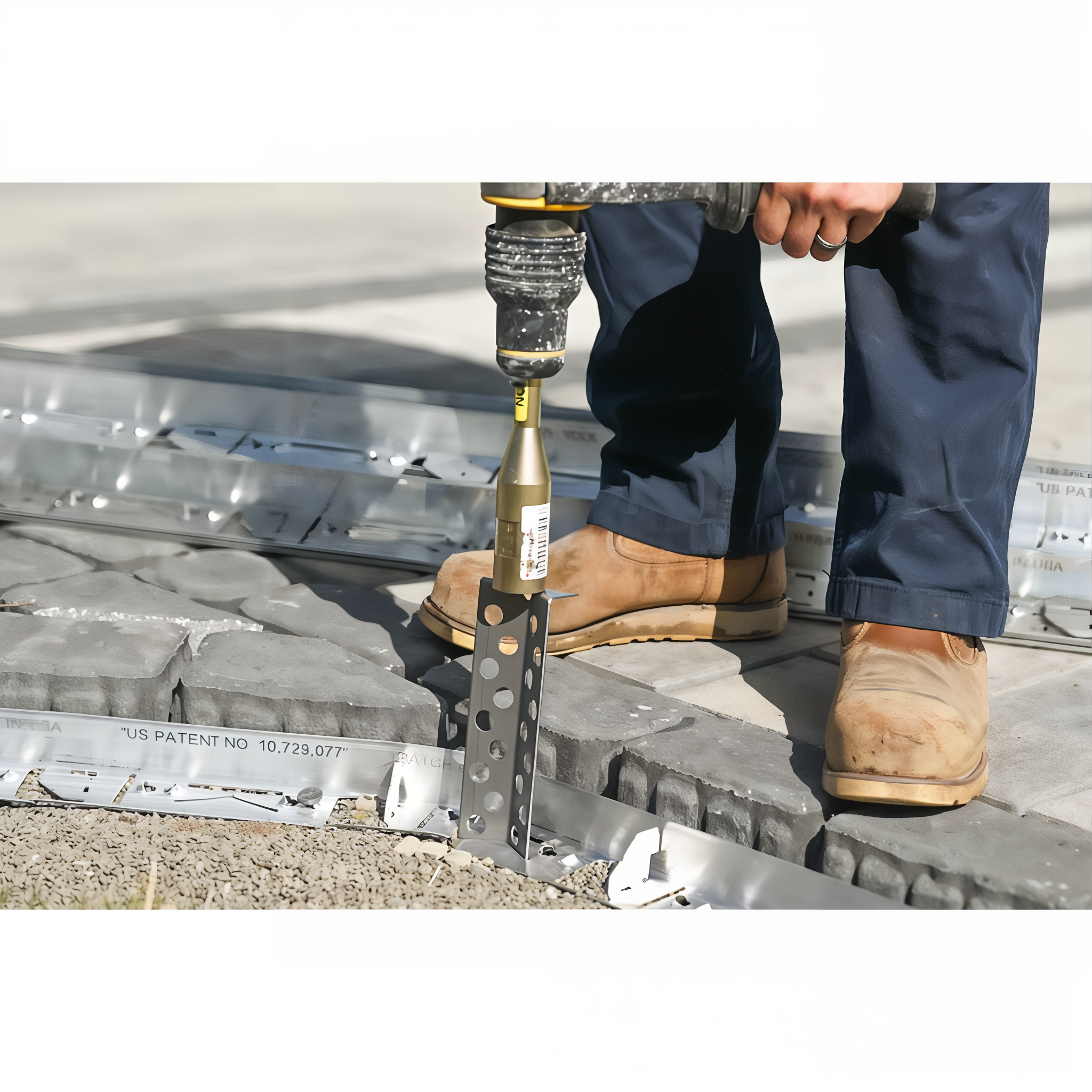Pave Tool Quick-E-Hammer driving Hybrid HD stakes into PVC paver edging on a job site