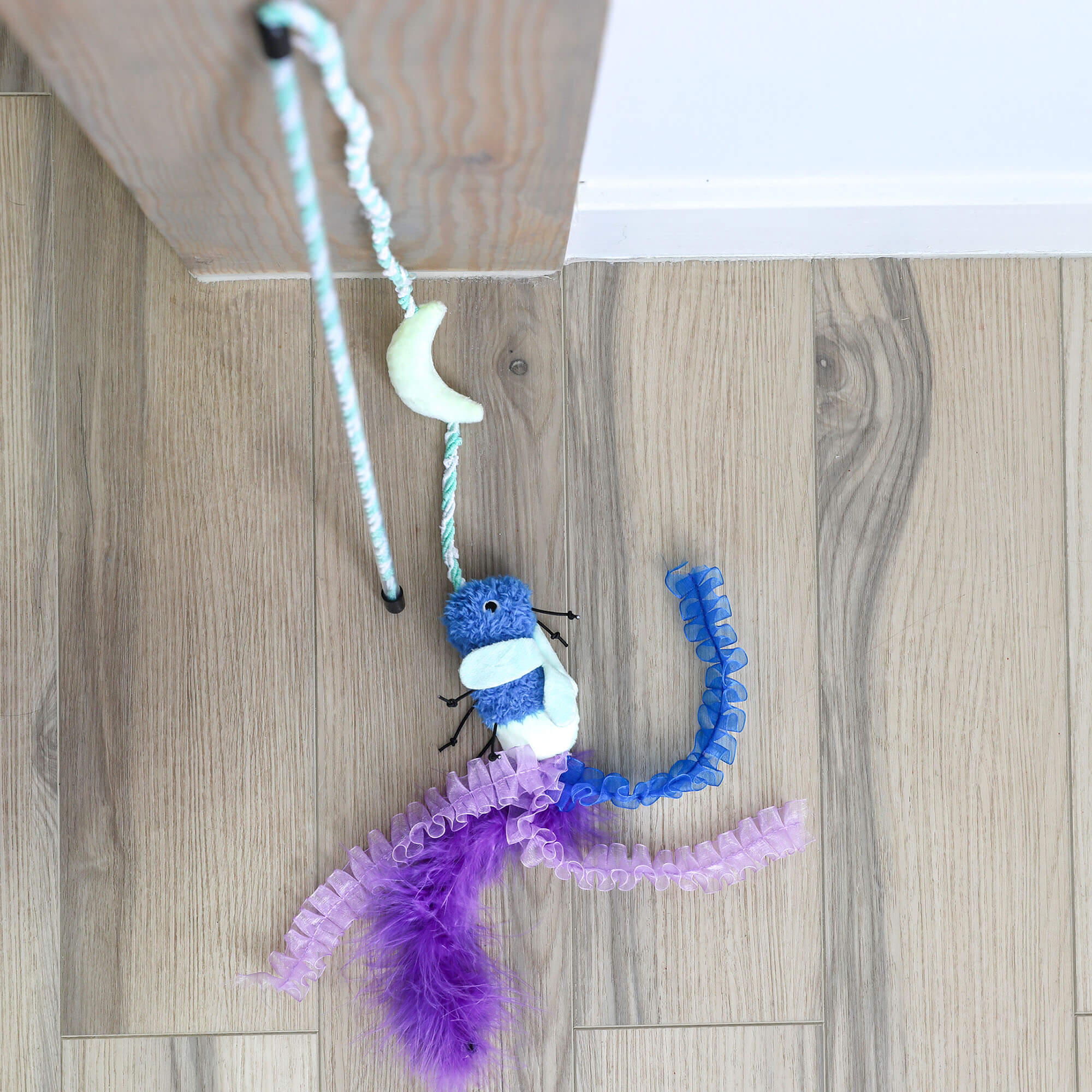Overhead view of the Quirky Kitty Firefly Wand firefly character and feather tail