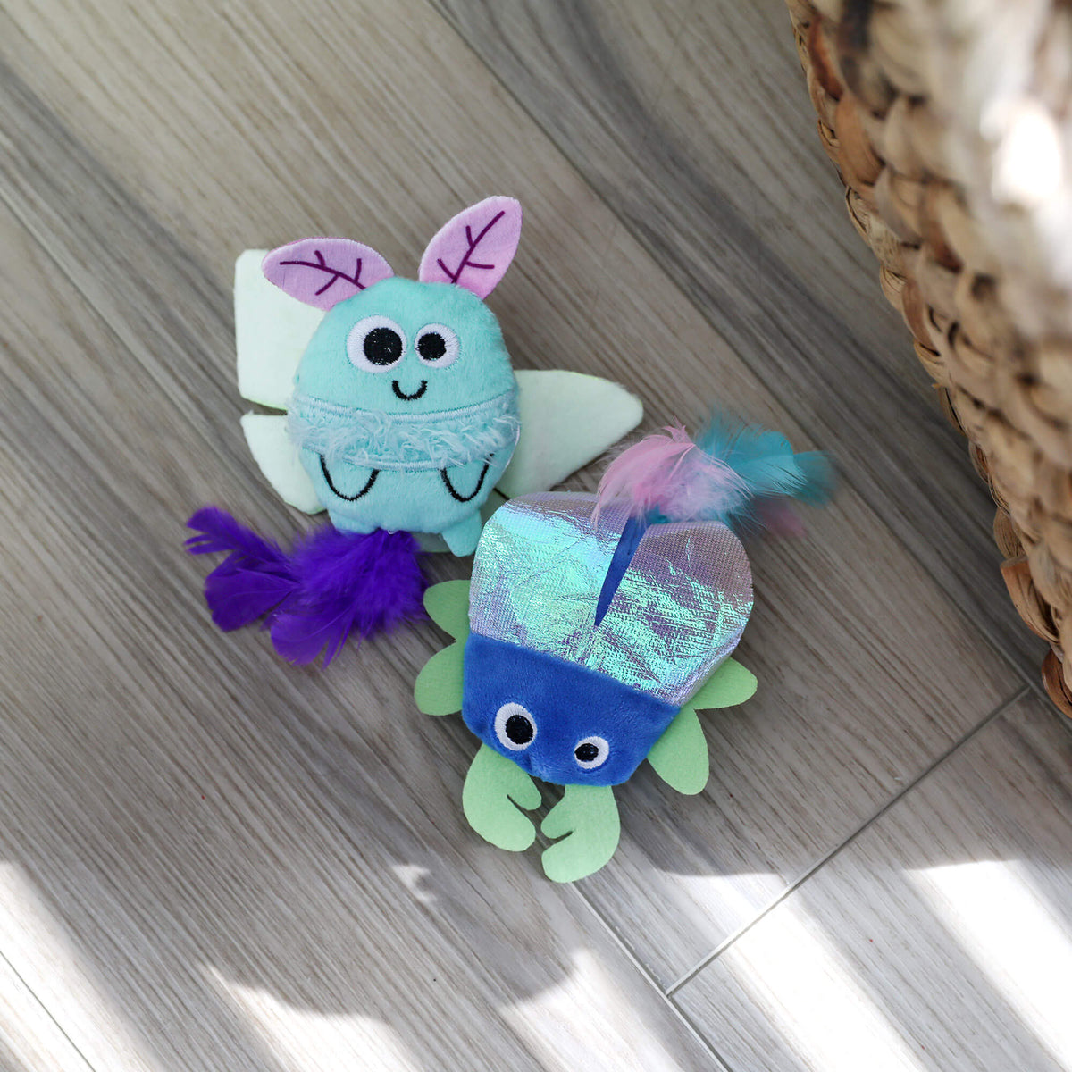 Quirky Kitty Luna Bugs luna moth and iridescent beetle toys on a wood floor