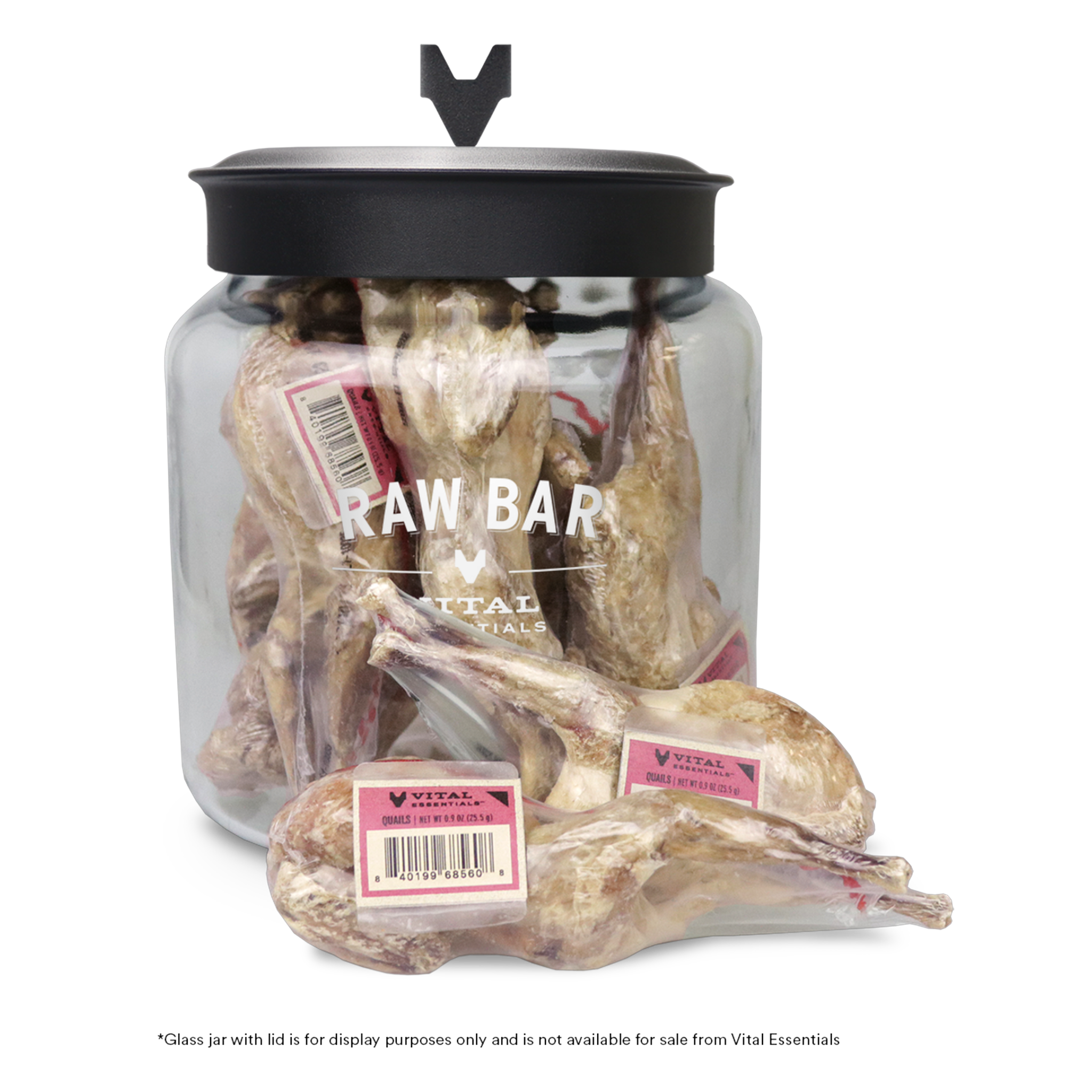 Vital Essentials Raw Bar shrink-wrapped whole quail dog treats with band labels in front of the Raw Bar display jar
