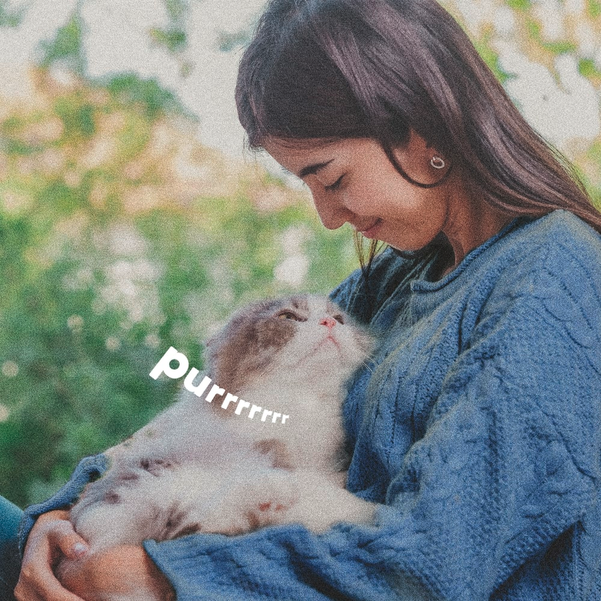 Woman holding her cat outdoors in a treated yard