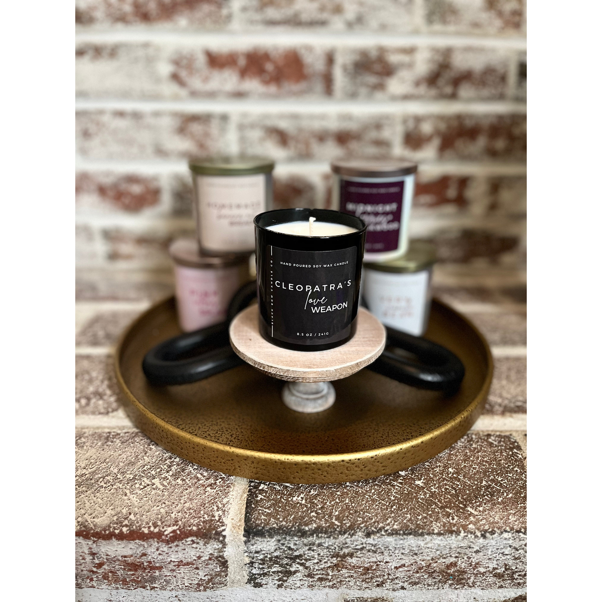 Black Bow Candle Co. Cleopatra's Love Weapon 17 oz 3-Wick Soy Candle -- lifestyle styled scene with scent collection