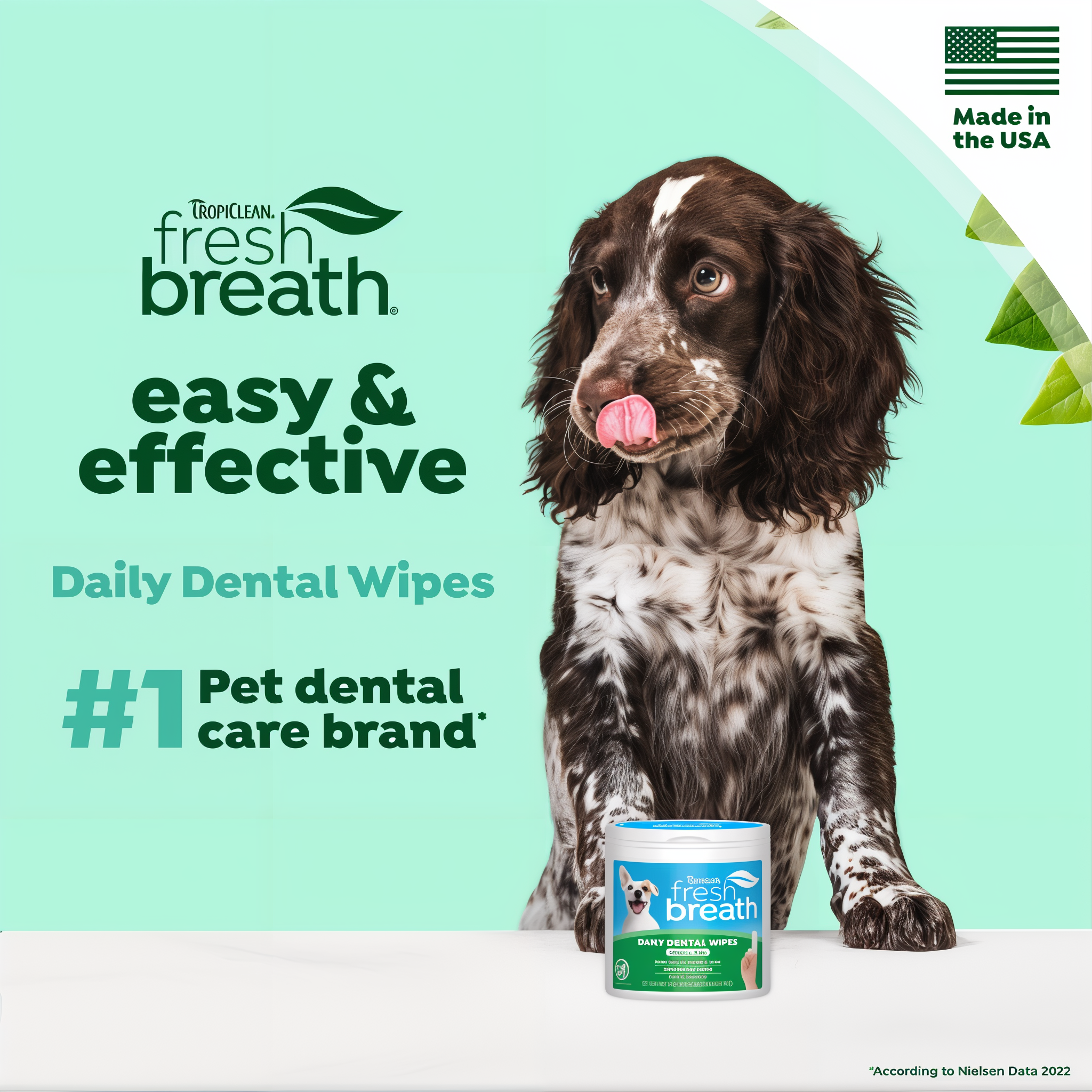 Dog with a container of TropiClean Fresh Breath Finger Dental Wipes for Pets