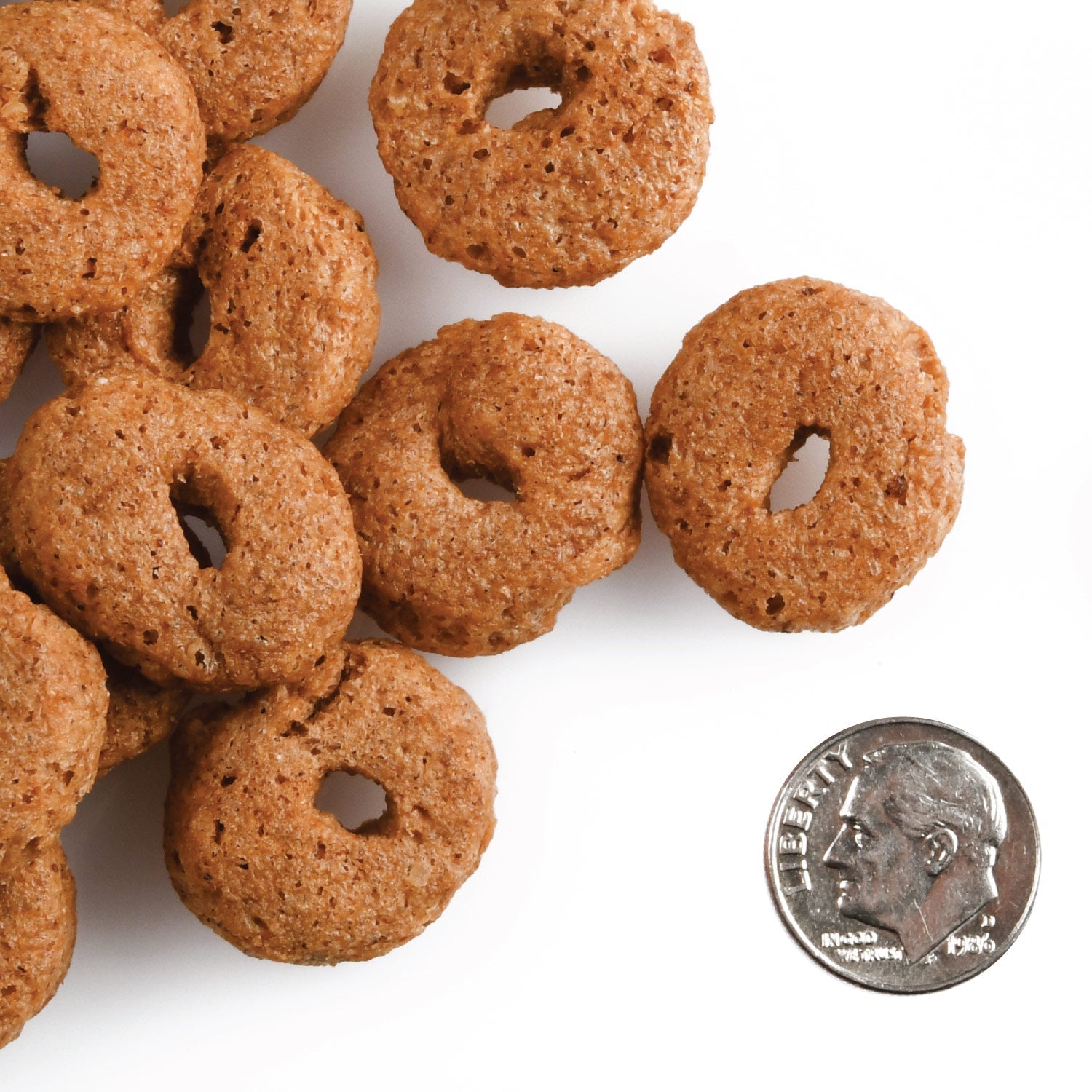 Banana Kablammas O-shaped treats next to a US dime for scale
