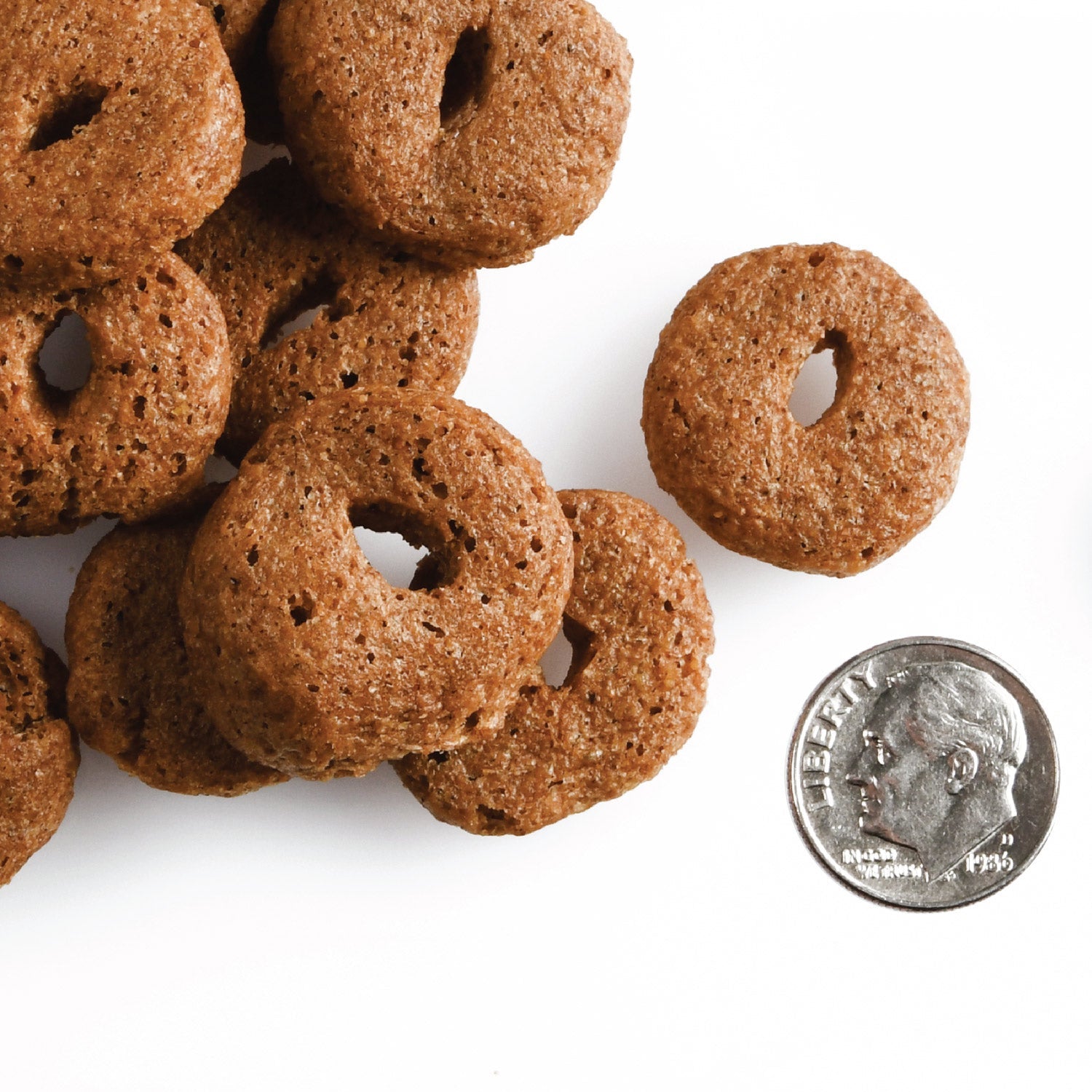 O-shaped Fromm Crunchy O's Pot Roast Punchers treats next to a dime for scale