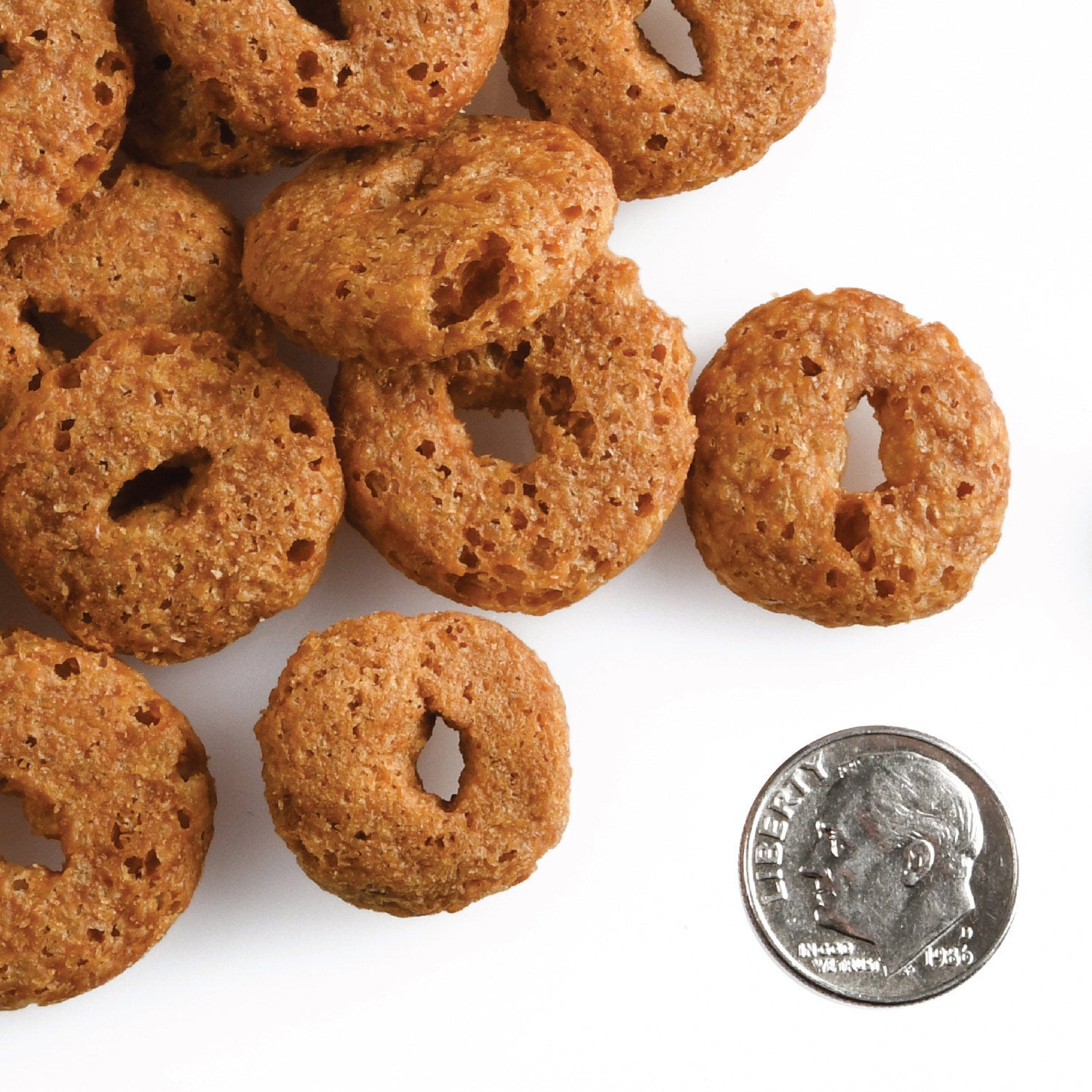 Fromm Crunchy O's Smokin' CheesePlosions O-shaped treats shown next to a US dime for scale
