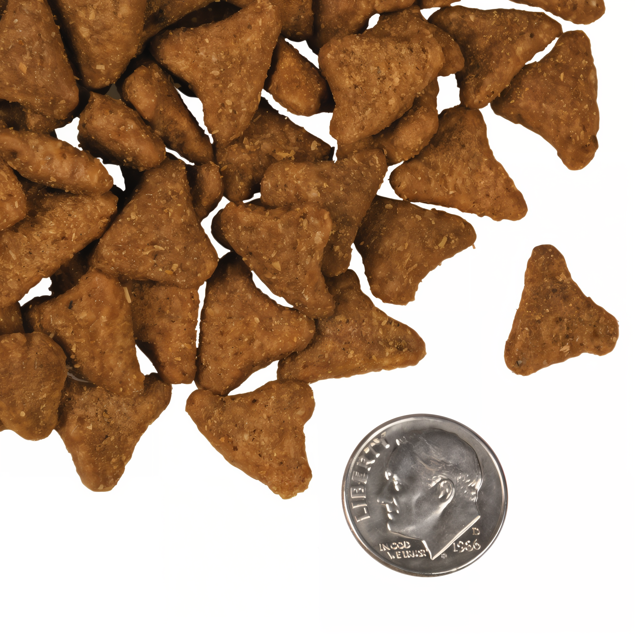 A small pile of Fromm Four-Star Whitefish and Potato kibble next to a dime for scale