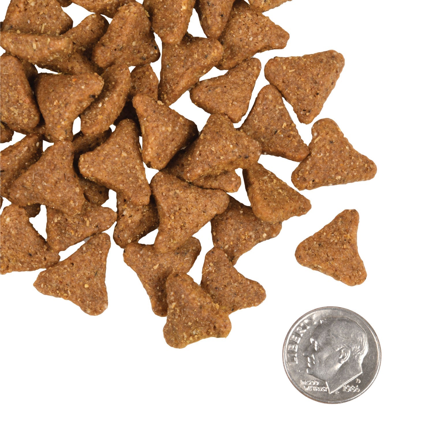 A small pile of Fromm Gold with Ancient Grains triangular kibble next to a dime for scale