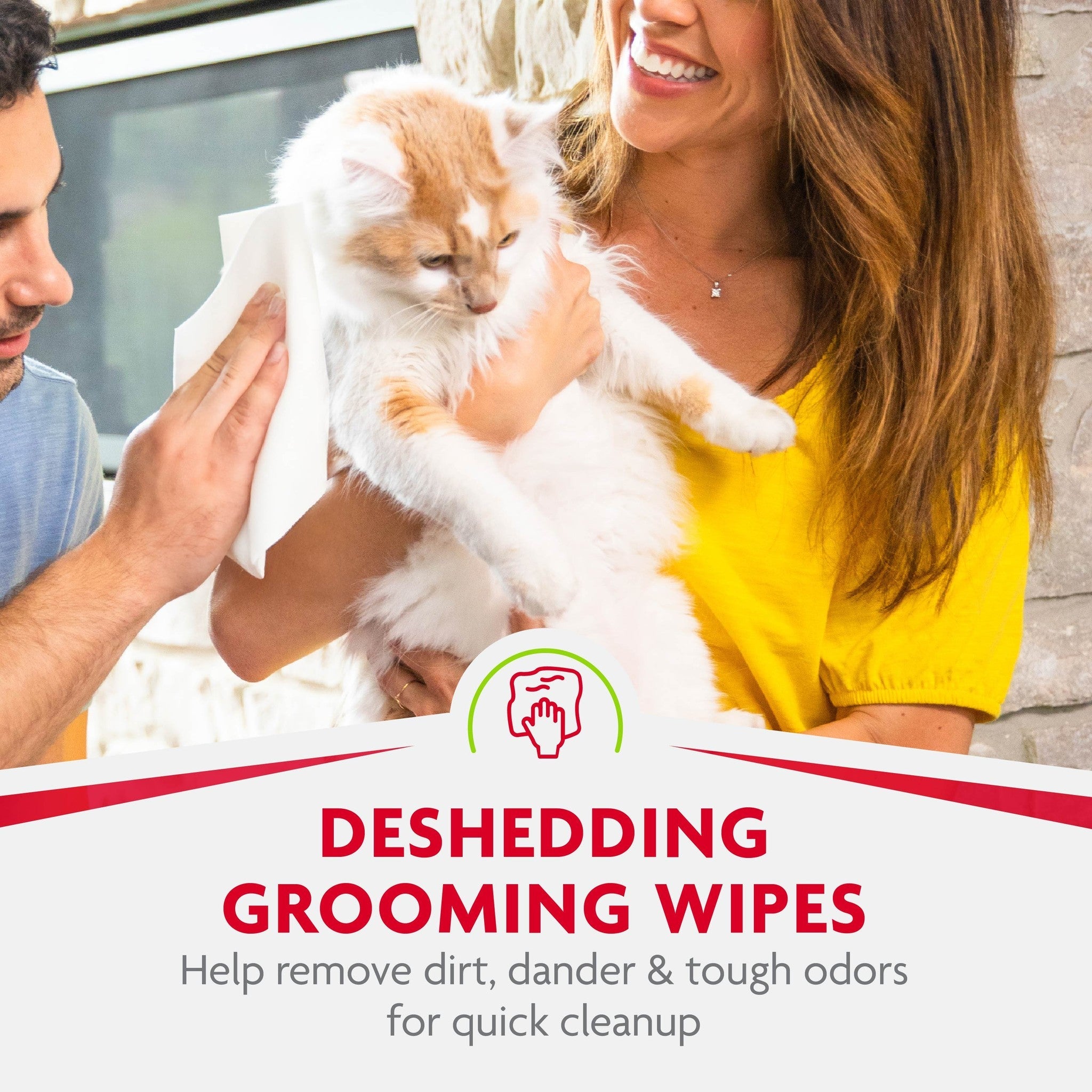Person wiping a cat with FURminator deShedding grooming wipes