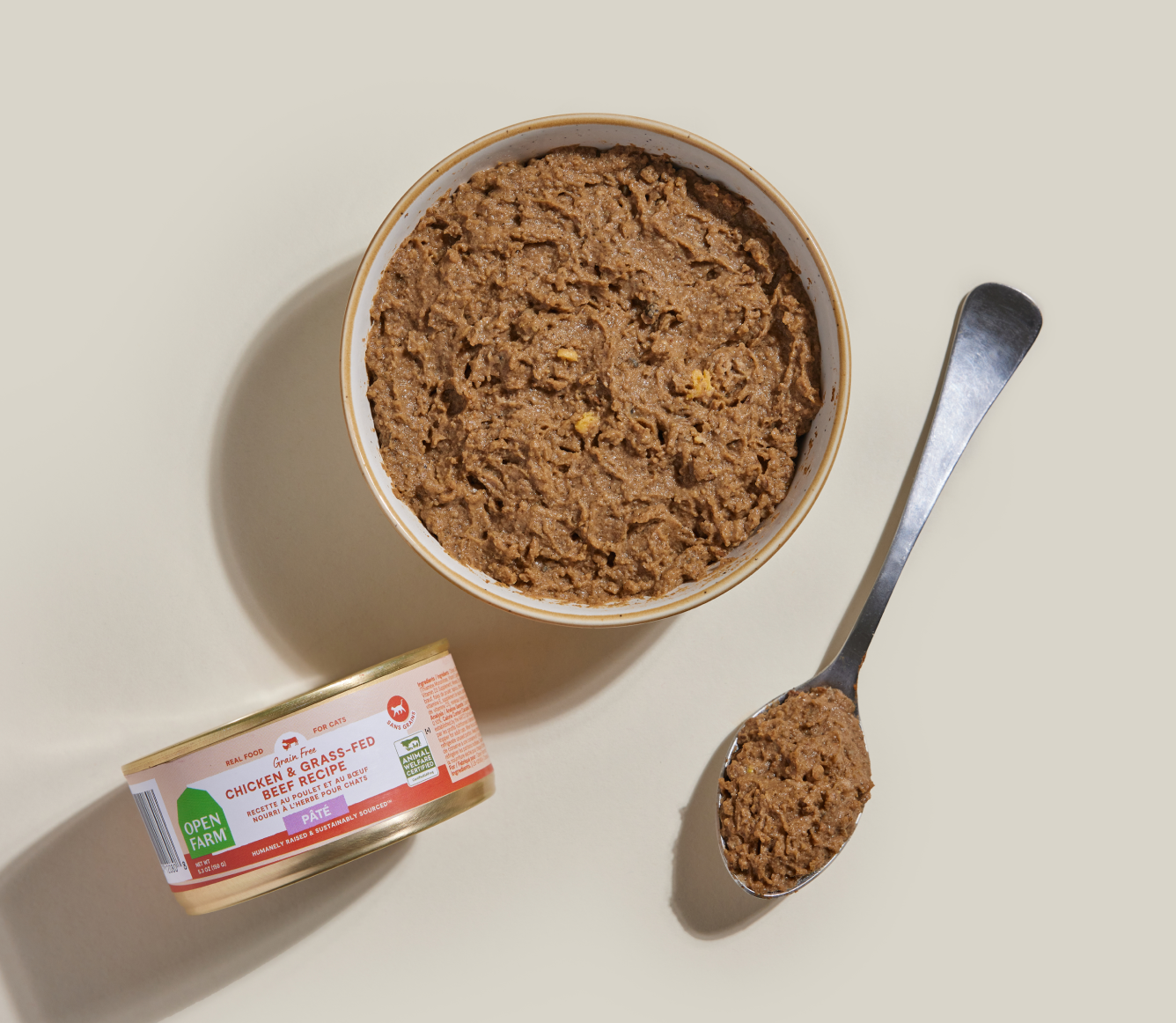 Open Farm chicken & grass-fed beef pâté served in a bowl beside the can and a spoon