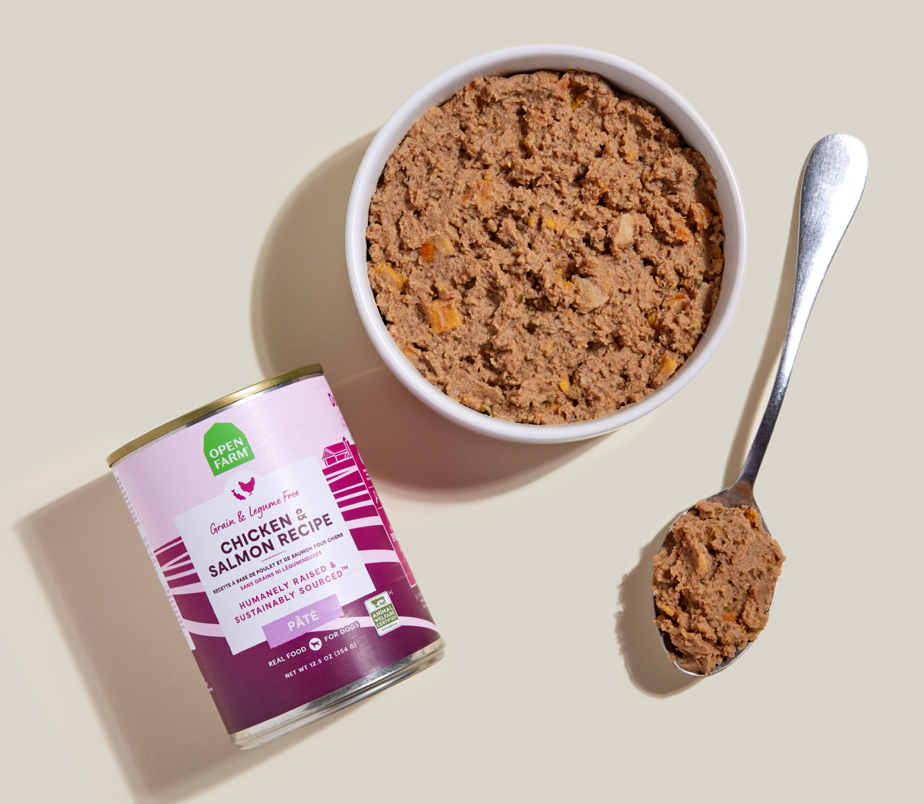 Open Farm Chicken & Salmon Pâté for Dogs 12.5 oz can beside a bowl of food