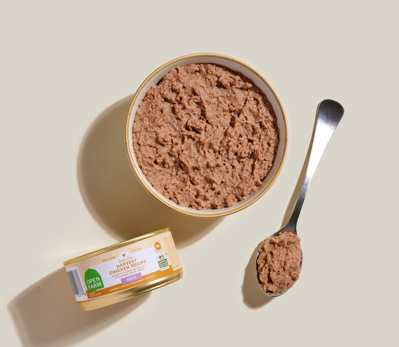 Open Farm harvest chicken pâté served in a bowl beside the can and a spoon