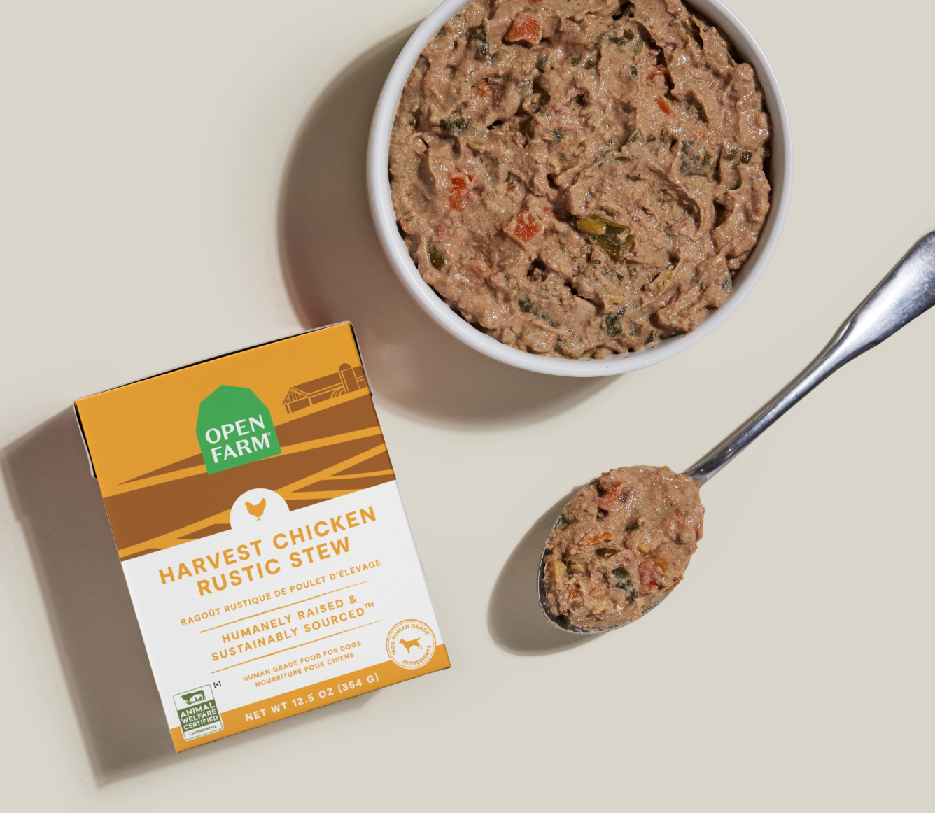 Open Farm Harvest Chicken Rustic Stew Wet Dog Food 12.5 oz carton beside a bowl of food