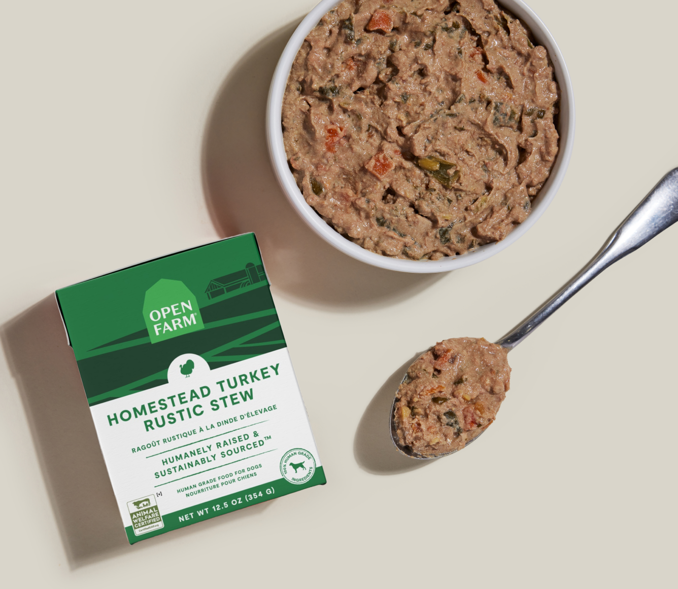 Open Farm Homestead Turkey Rustic Stew Wet Dog Food 12.5 oz carton beside a bowl of food
