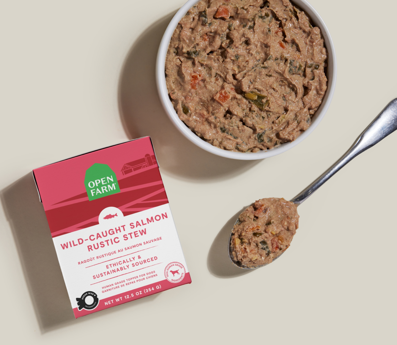 Open Farm Wild-Caught Salmon Rustic Stew Topper for Dogs 12.5 oz carton beside a bowl of food