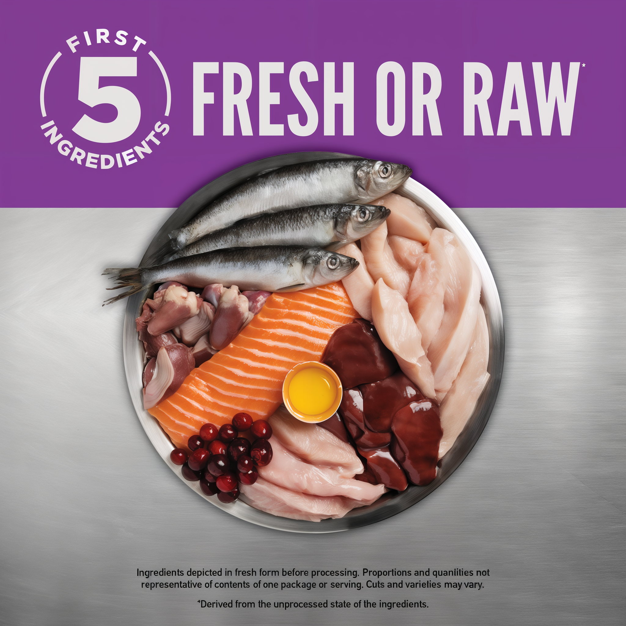 First 5 ingredients fresh or raw: a bowl of whole herring, salmon, chicken, turkey giblets, chicken liver, cranberries, and a cracked egg for ORIJEN Kitten cat food