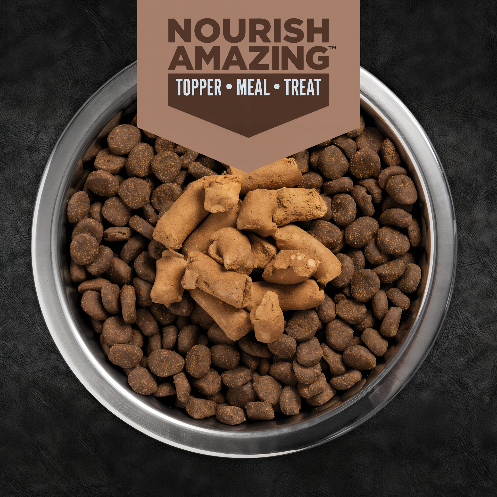 Stainless steel bowl of dry kibble topped with ORIJEN Regional Red Epic Bites freeze-dried pieces, labeled Nourish Amazing topper, meal and treat