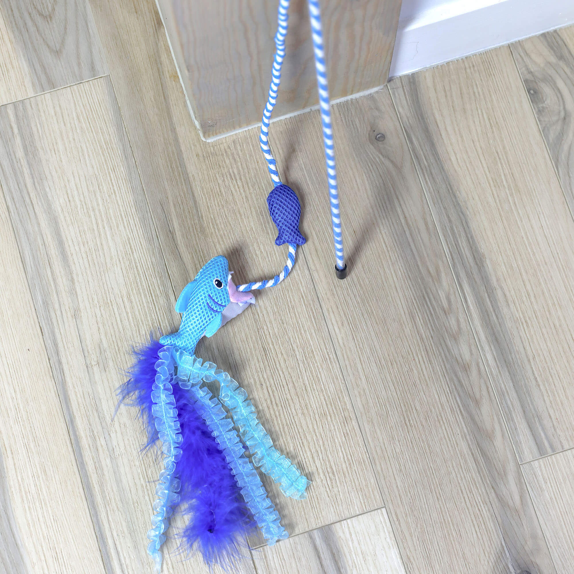 Close-up of the Quirky Kitty Cool Shark Wand shark character and blue feather tail