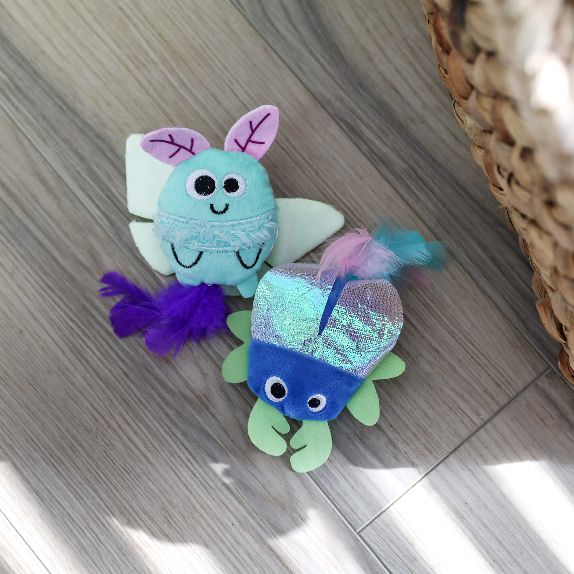 Quirky Kitty Luna Bugs luna moth and iridescent beetle toys on a wood floor