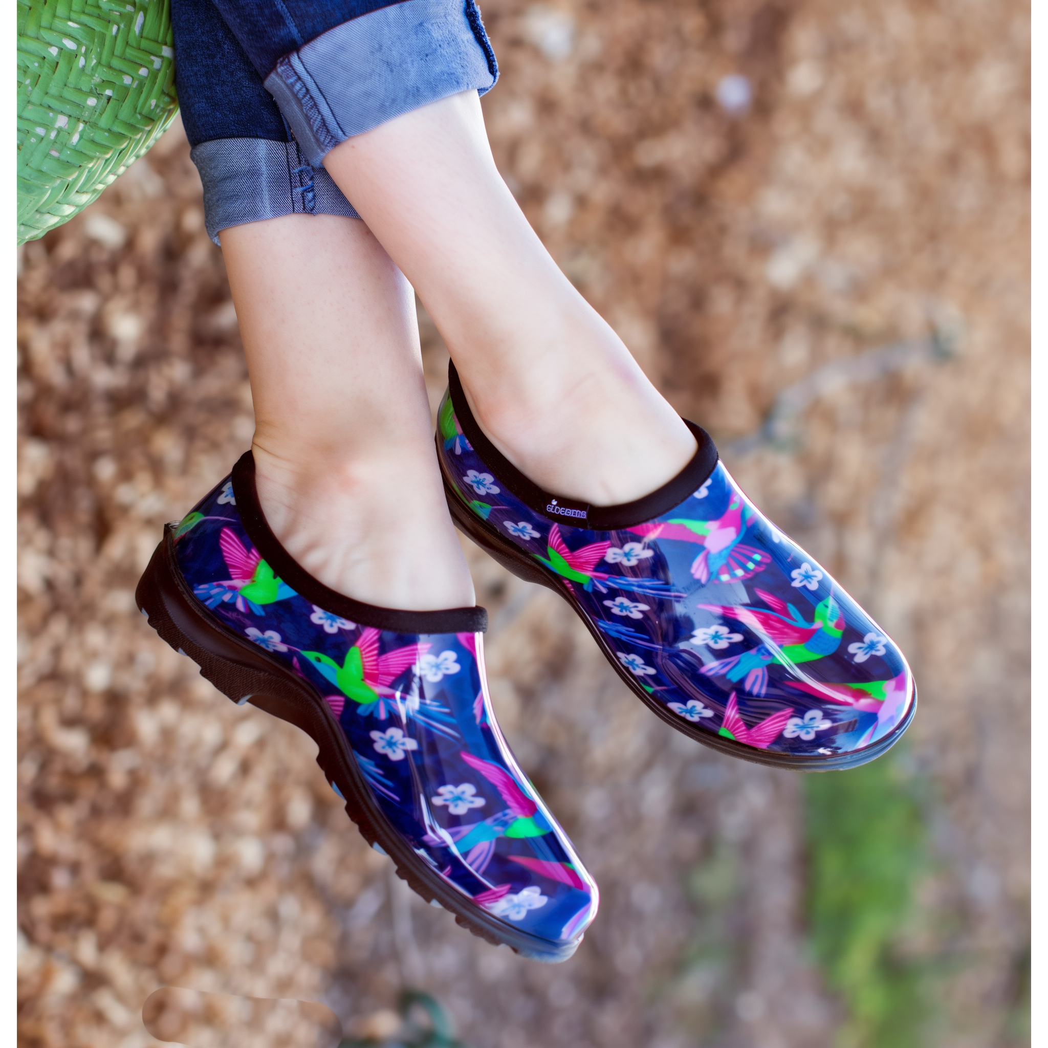 Hummingbird Blue-Pink Sloggers garden shoe pair shown on a porch deck