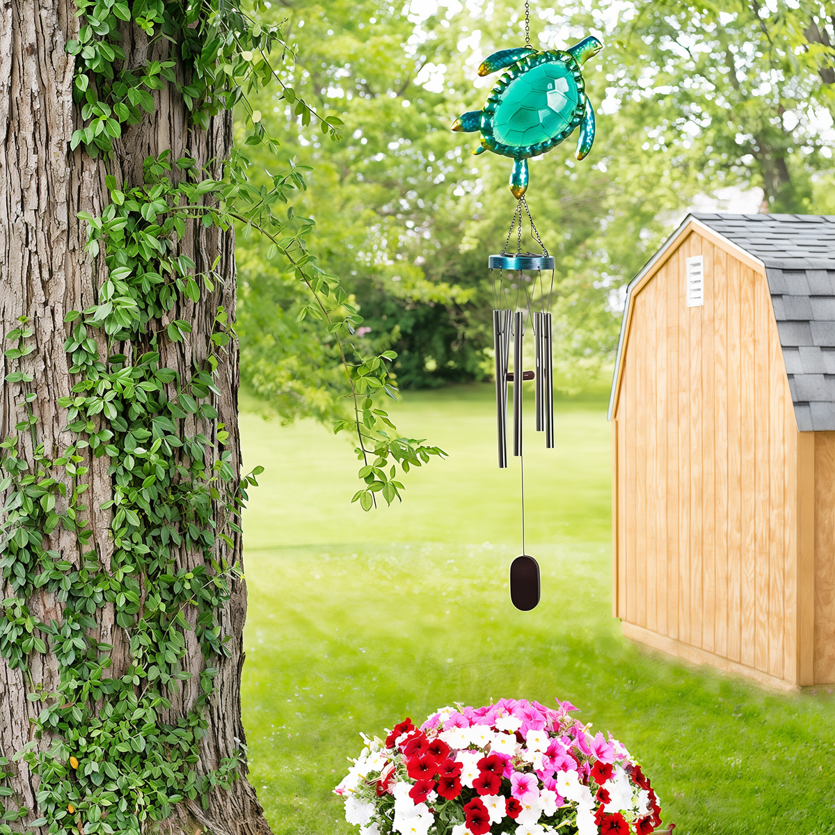 Sunset Vista Designs Solar Sea Turtle Wind Chime -- shown hanging in a garden