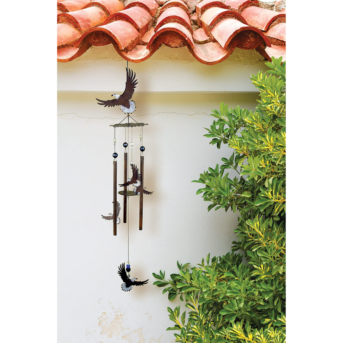 Sunset Vista Designs Wilderness Wonders Eagle Wind Chime -- shown hanging under a porch eave