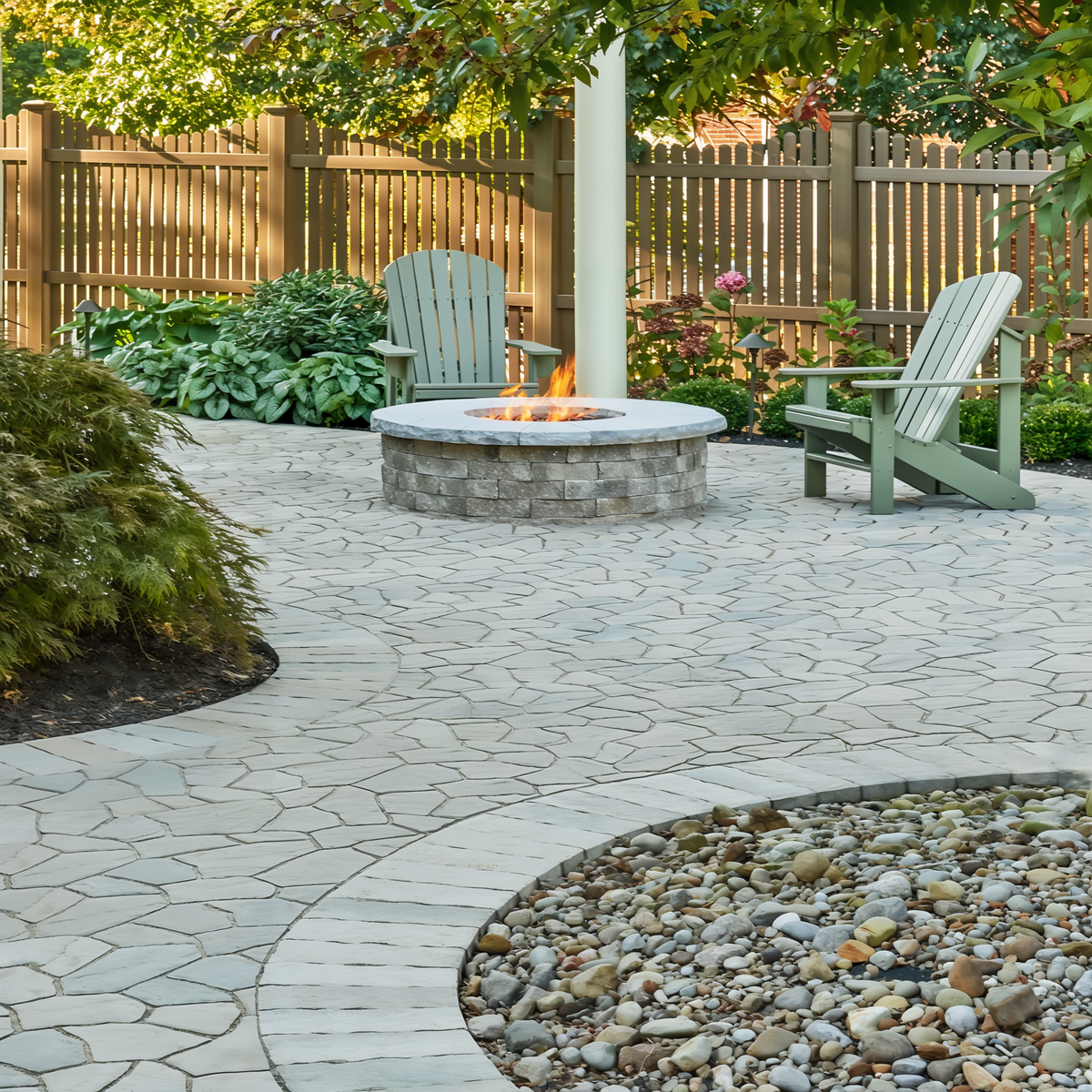 Valencia Fire Pit in Champlain Grey with natural stone layout and garden seating.