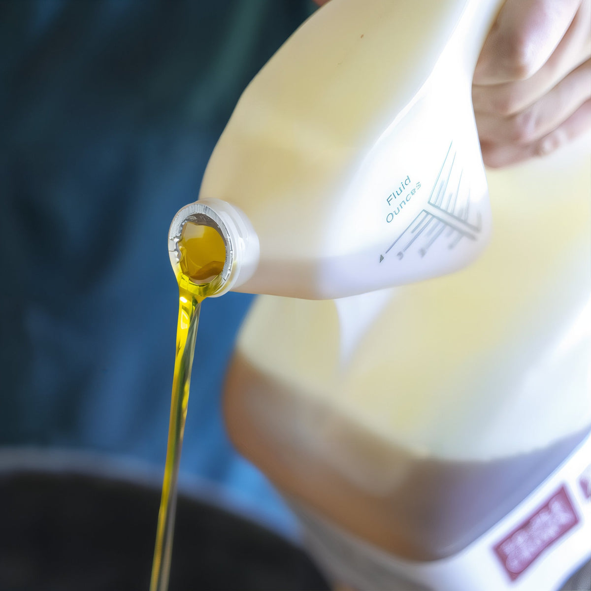 Triple Crown Essential Omega Blend oil pouring from the jug spout
