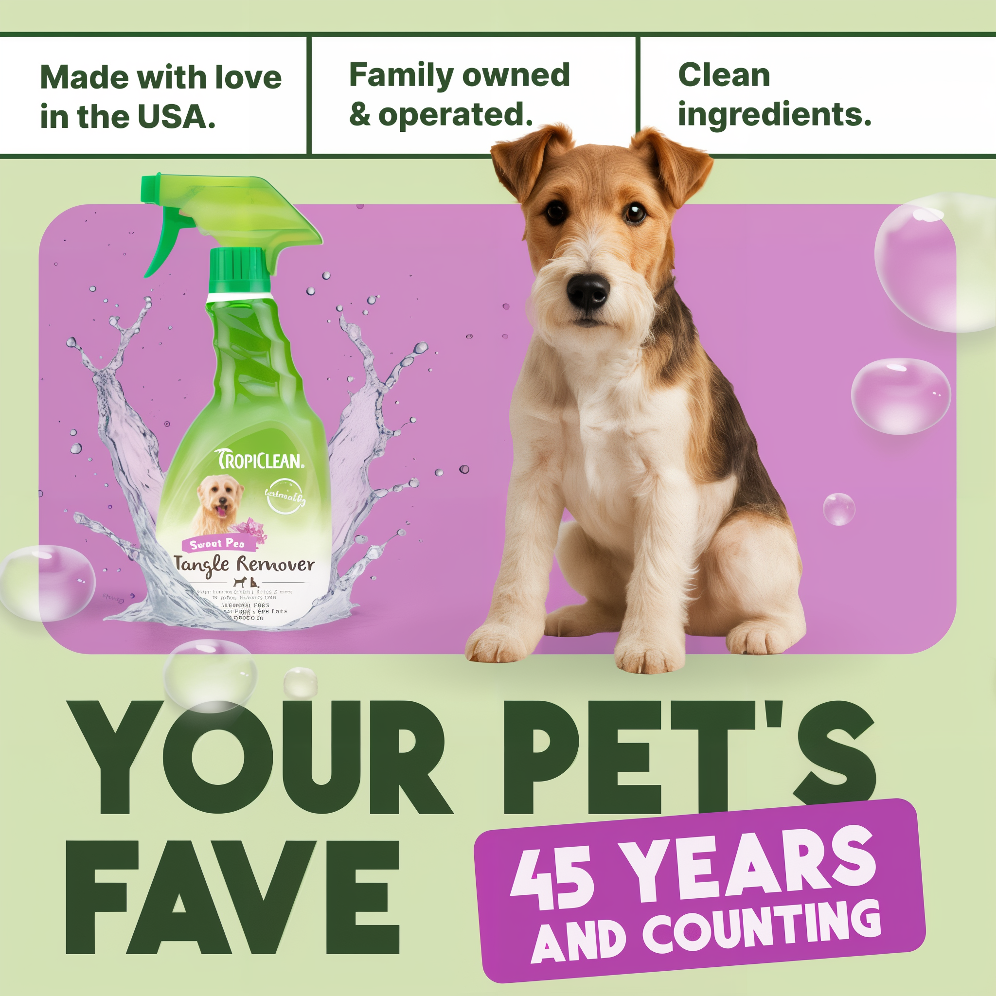 TropiClean Island Bloom Tangle Remover pet spray bottle with green trigger sprayer and purple label next to brown and white d