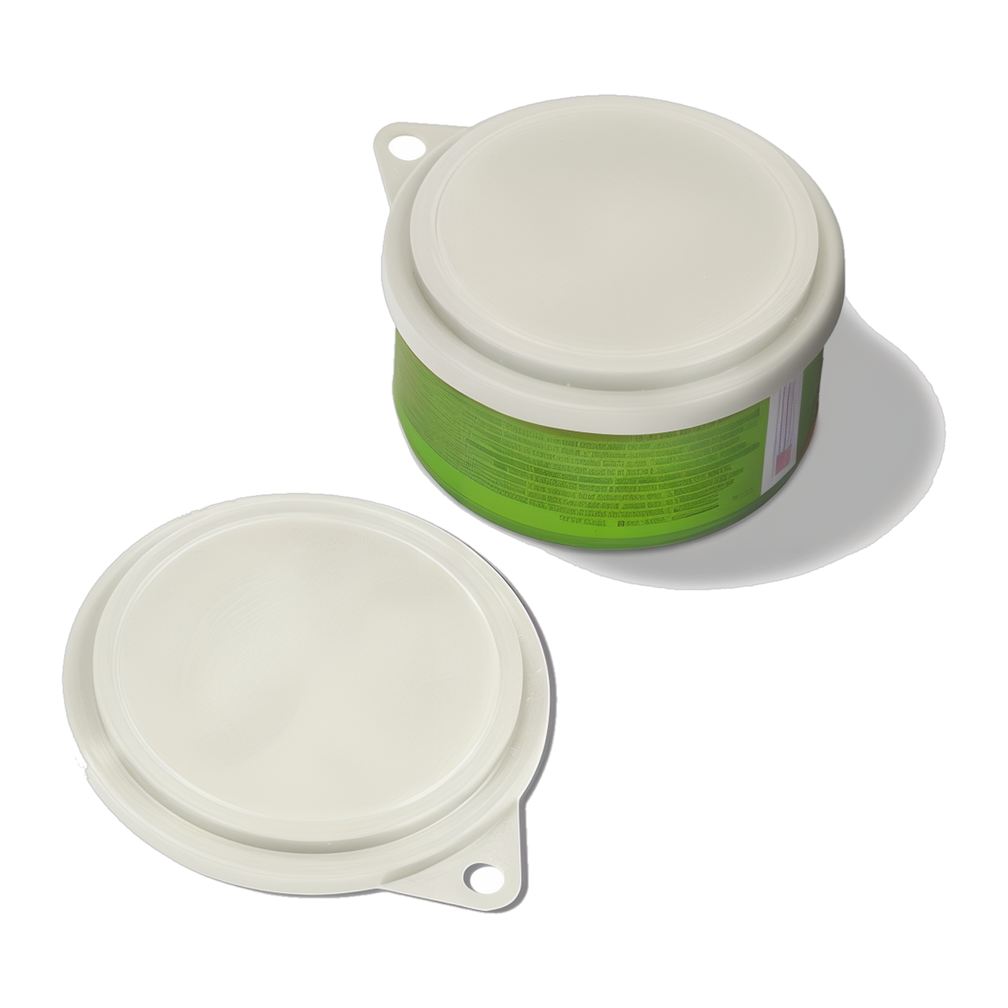 Van Ness Pet Food Can Cover sealed on an open pet food can with a second cover beside it